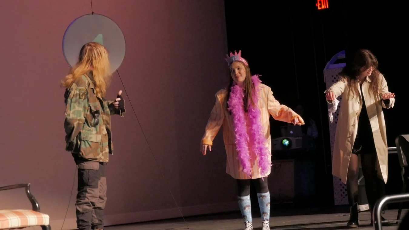 Caroline jones with a colorful costume, Joan Patrello, and Louise Jordan speaking in Jax Schuck's Entropy.