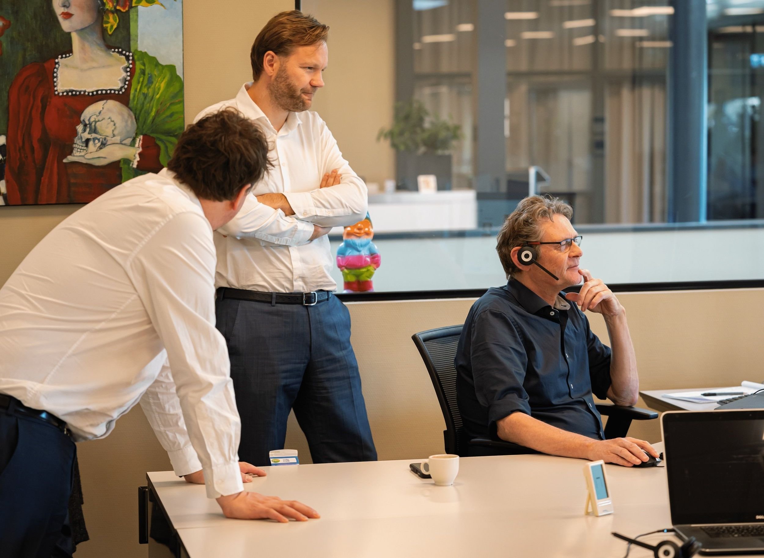 three men looking at screen