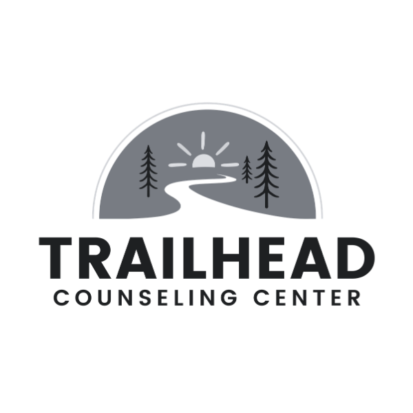 Logo for Trailhead Counseling Center featuring a sun rising over a winding trail and pine trees.