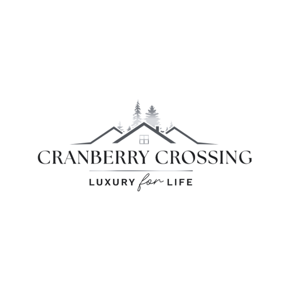 Logo for Cranberry Crossing featuring a house with a window, surrounded by pine trees, with the text "CRANBERRY CROSSING LUXURY for LIFE."