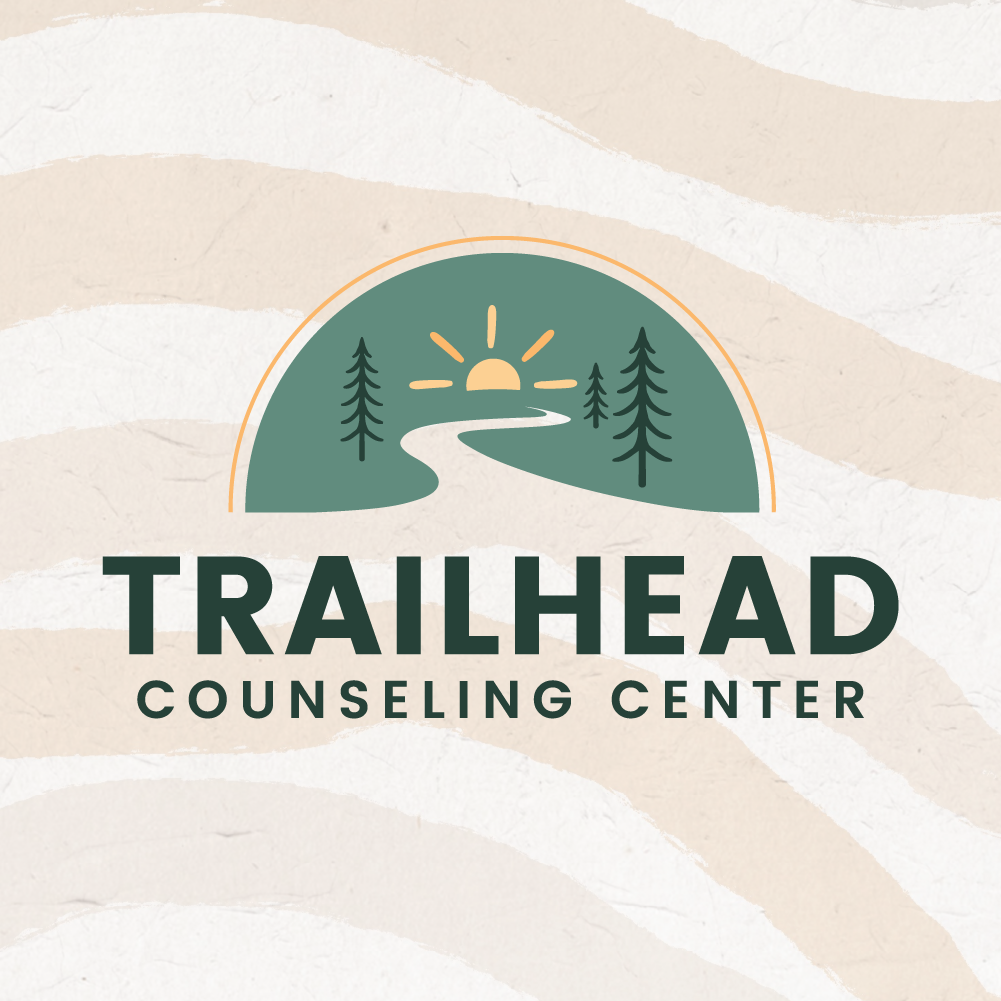 Logo for Trailhead Counseling Center featuring a stylized landscape with a sunset, trees, and a winding path.