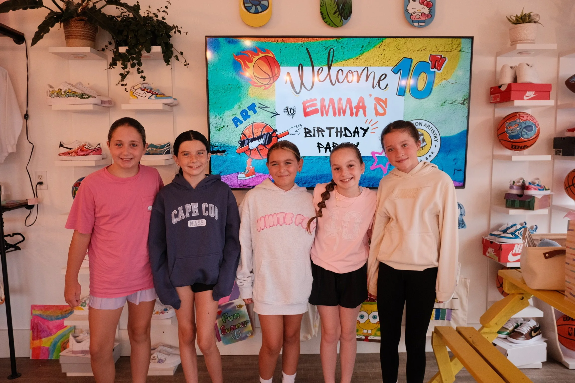 A group of children attending a custom art birthday party at The Boston Artistry sneaker bar in Hingham.