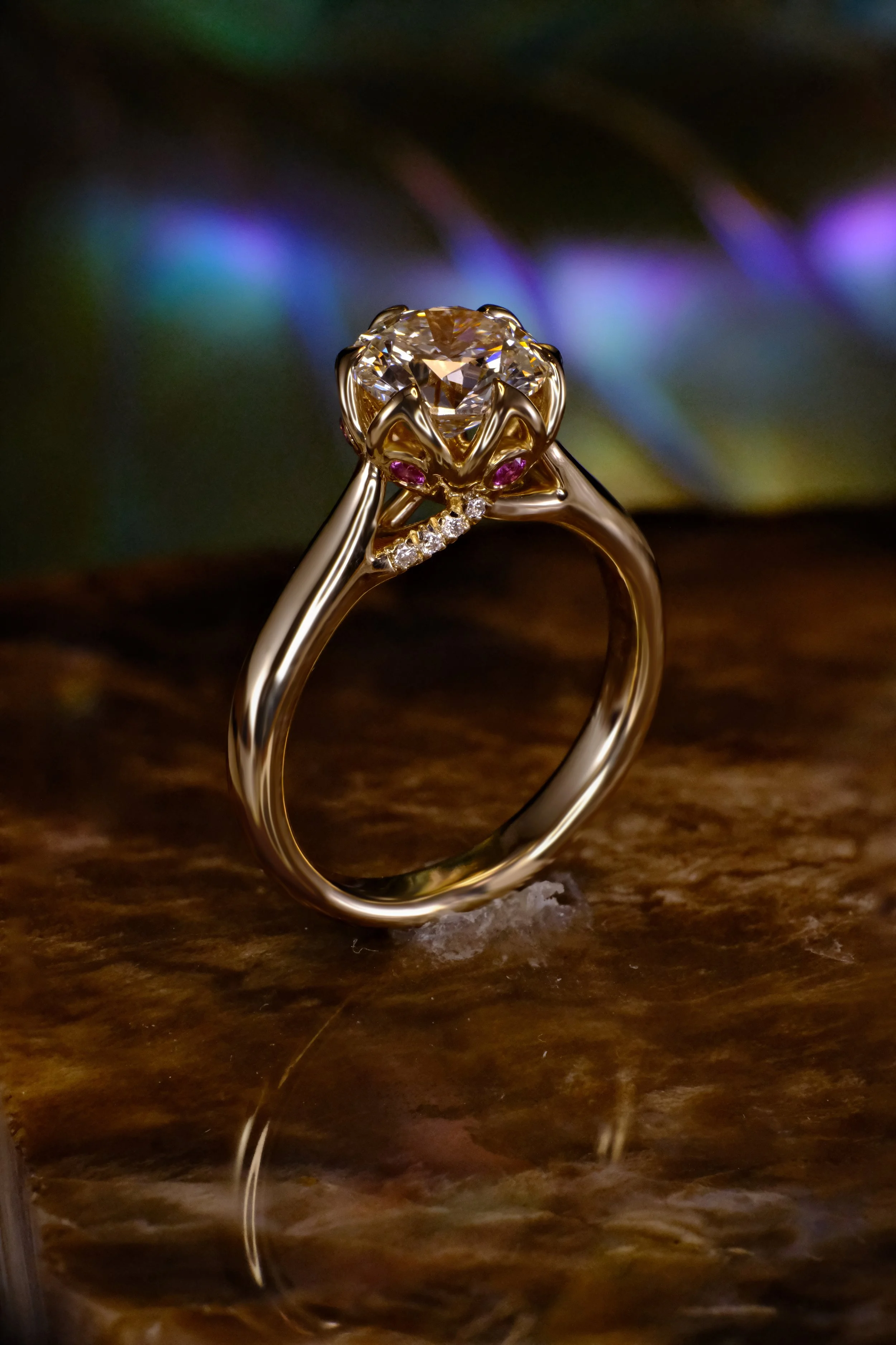 The Arcadia solitaire engagement ring, a side profile view displaying the elegant gold band and the sculptural basket setting that conceals a secret garden of floral accent stones beneath the center diamond.