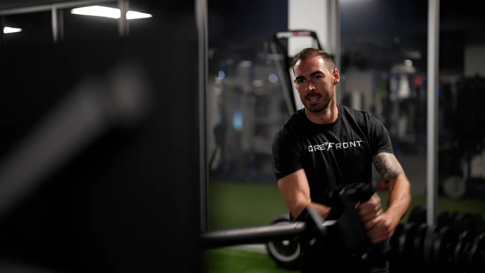 Training with resistance equipment in a Forefront shirt