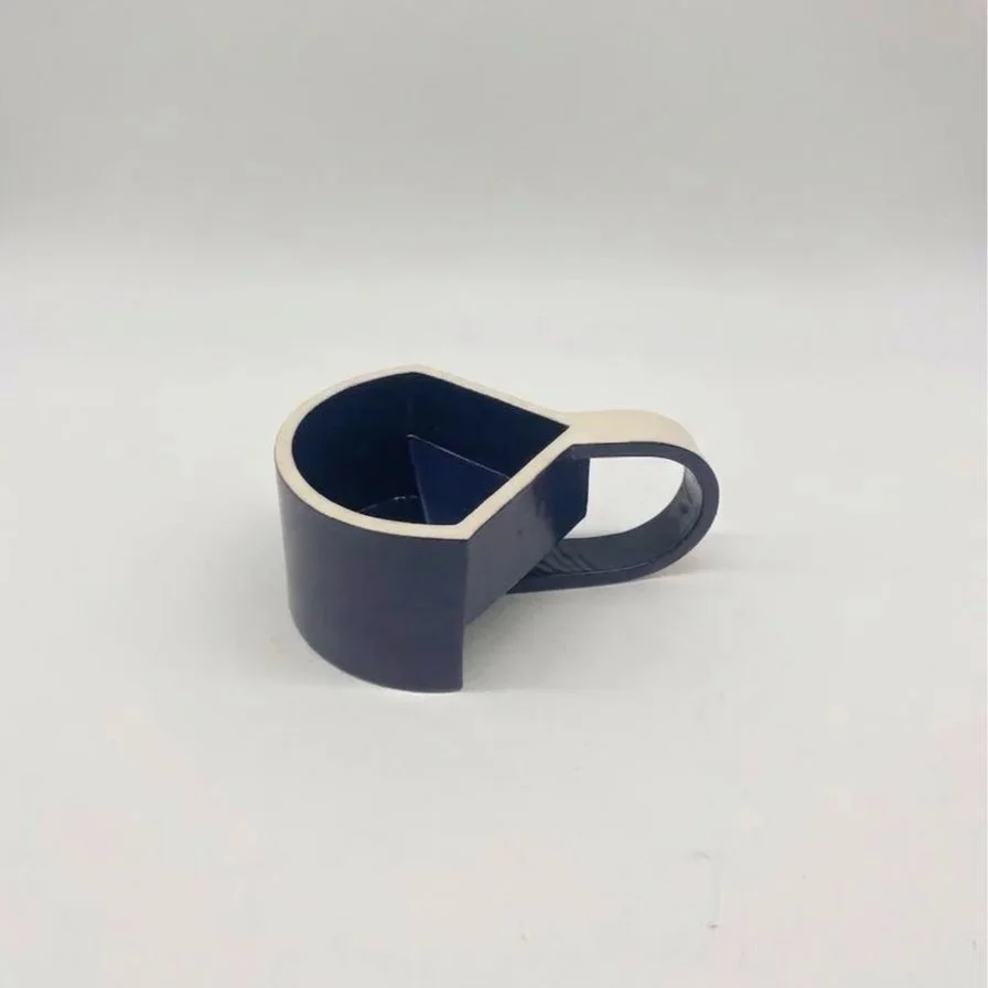A black and white tape dispenser on a plain white surface.