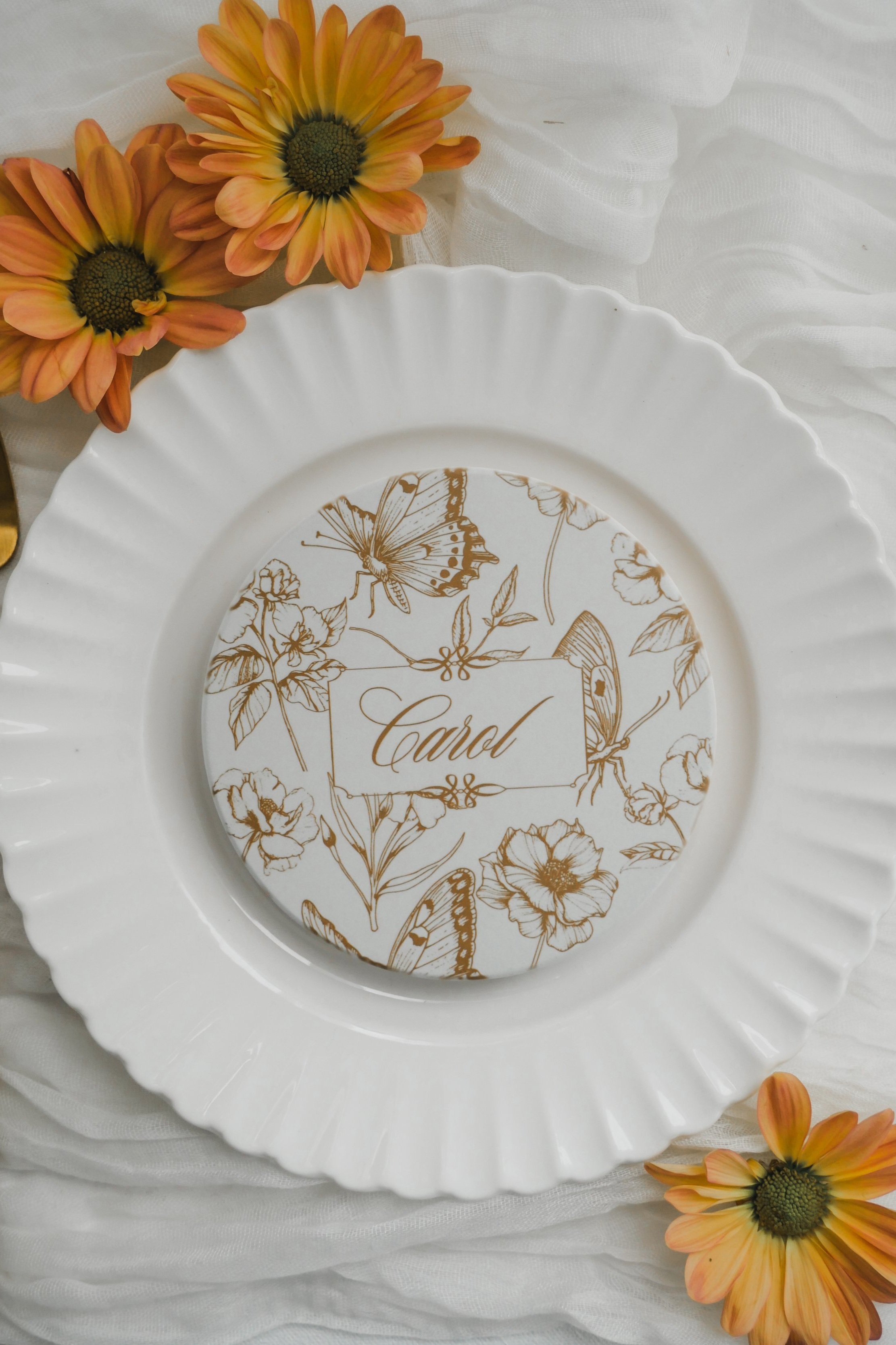 Marigold butterflies and flowers coaster on a white plate