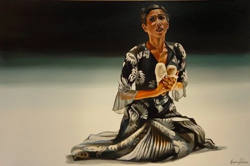 A woman kneeling on the ground, holding a pair of shoes, with a distressed facial expression, in a dark background.