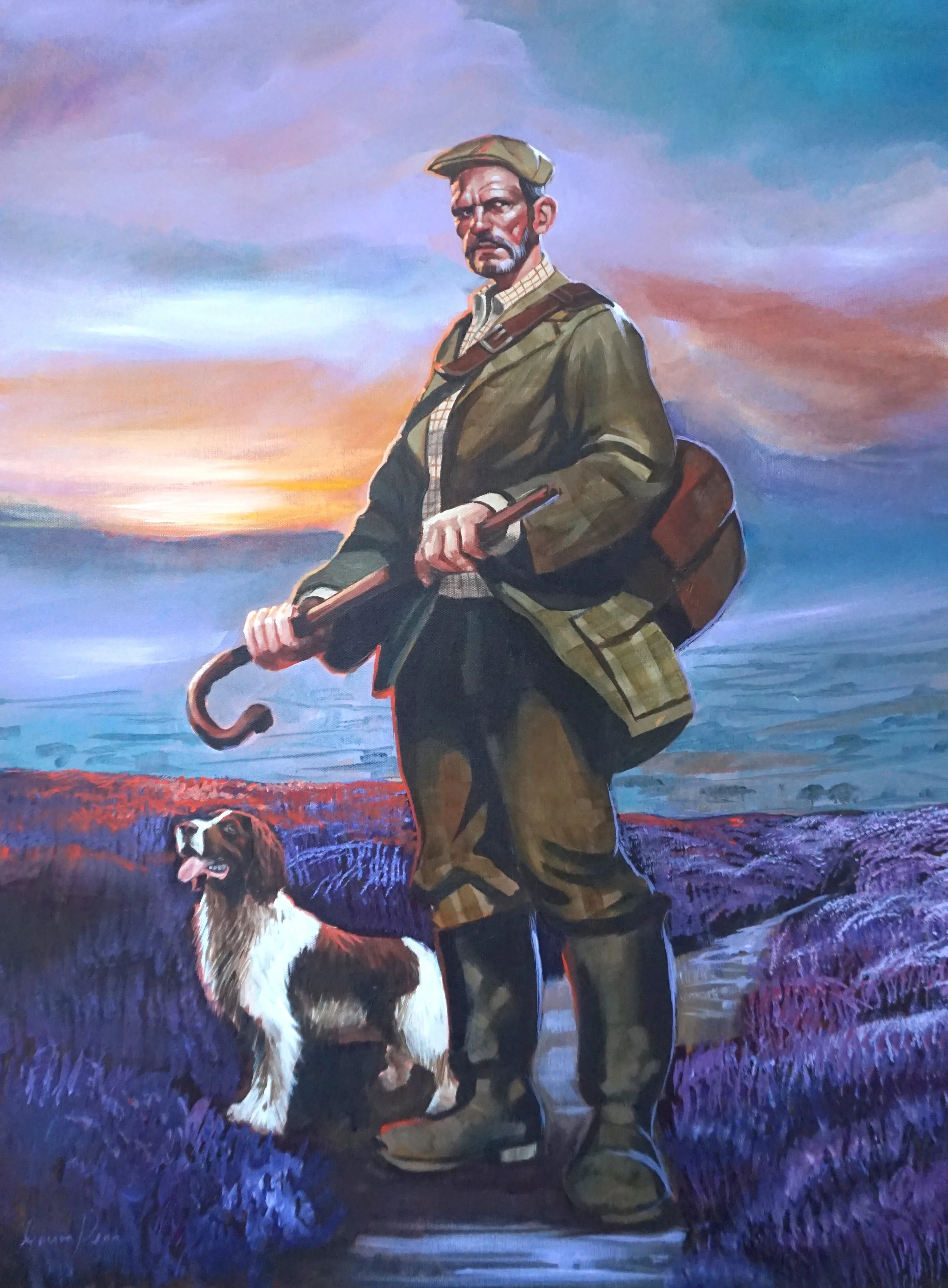 Painting of a man with a beard and mustache, wearing a hat, plaid shirt, and olive jacket, holding a cane, accompanied by a dog with white and brown fur, both standing on a rocky landscape at sunset with purple, orange, and blue sky.