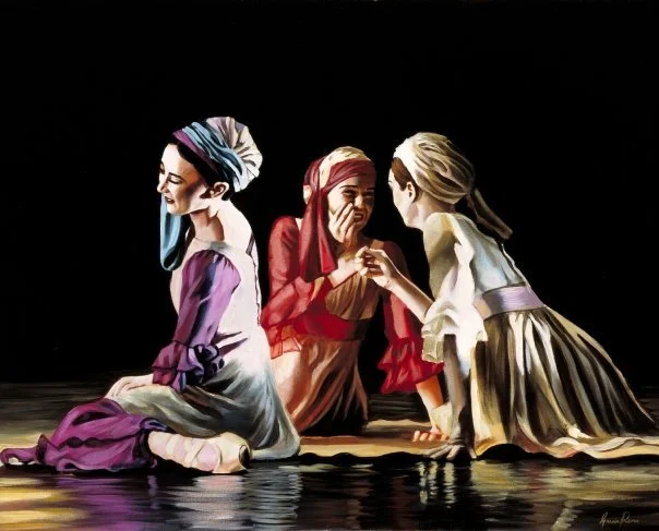 Three young women dressed in historical costumes sitting and kneeling on stage, engaging in a conversation against a dark background.