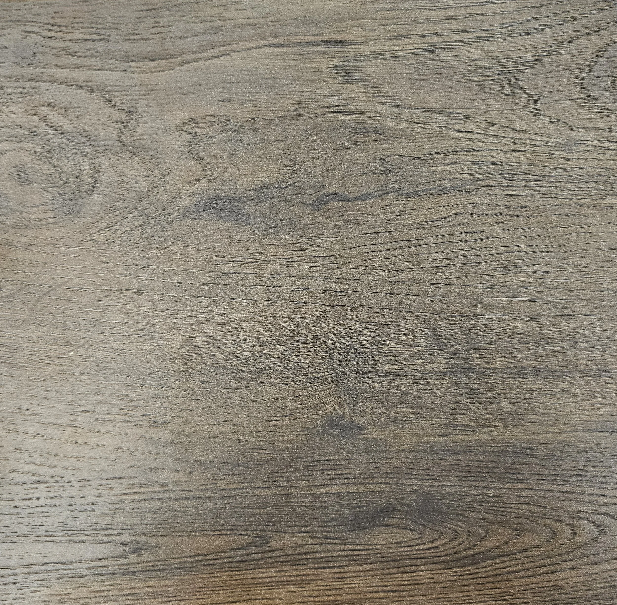Close-up of a wooden surface with visible wood grain and texture.