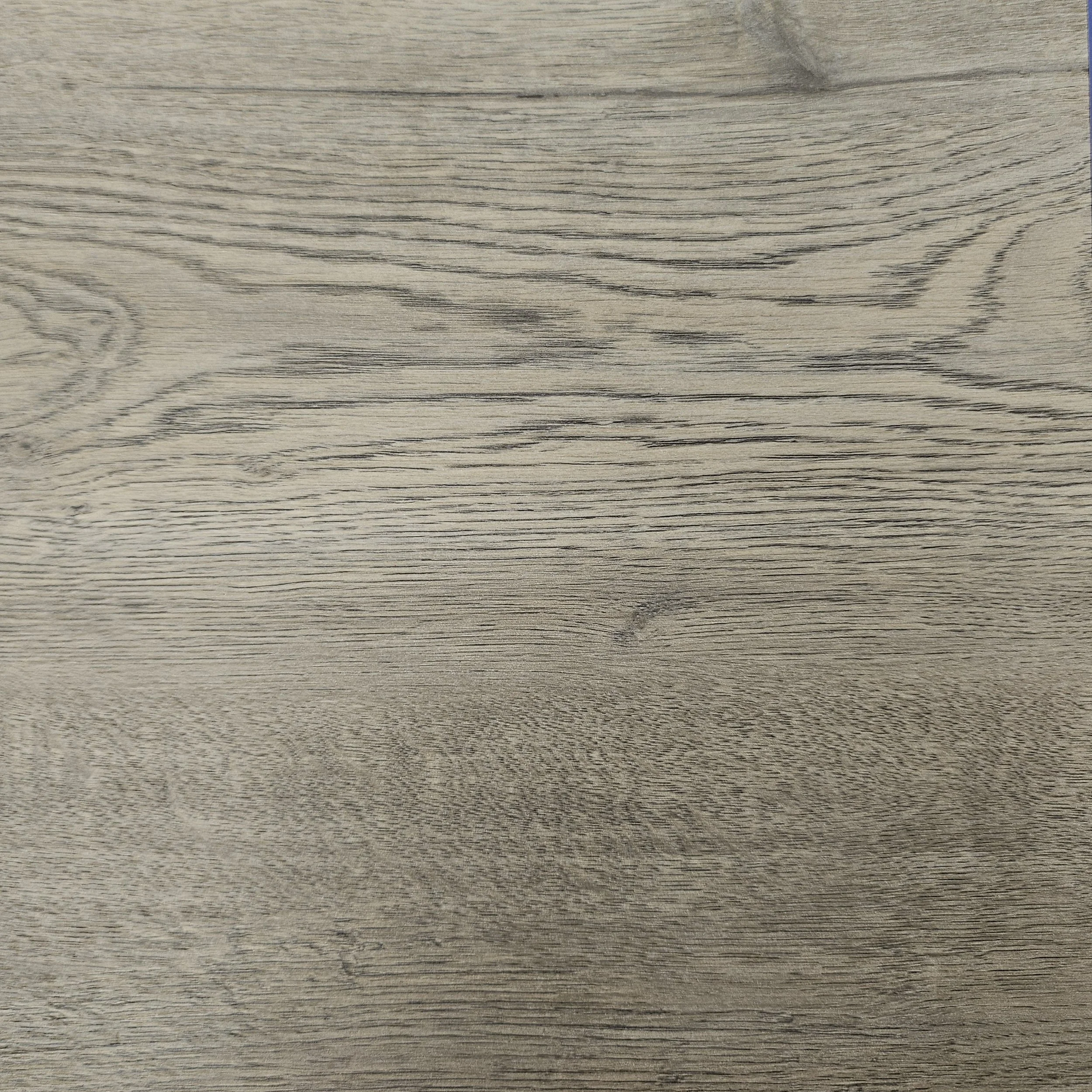 Close-up of light gray wood grain surface with visible texture and natural pattern.