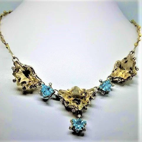 Fine handmade necklace of sterling silver with gold covered silver balls.Fancy cut citrines and topazes