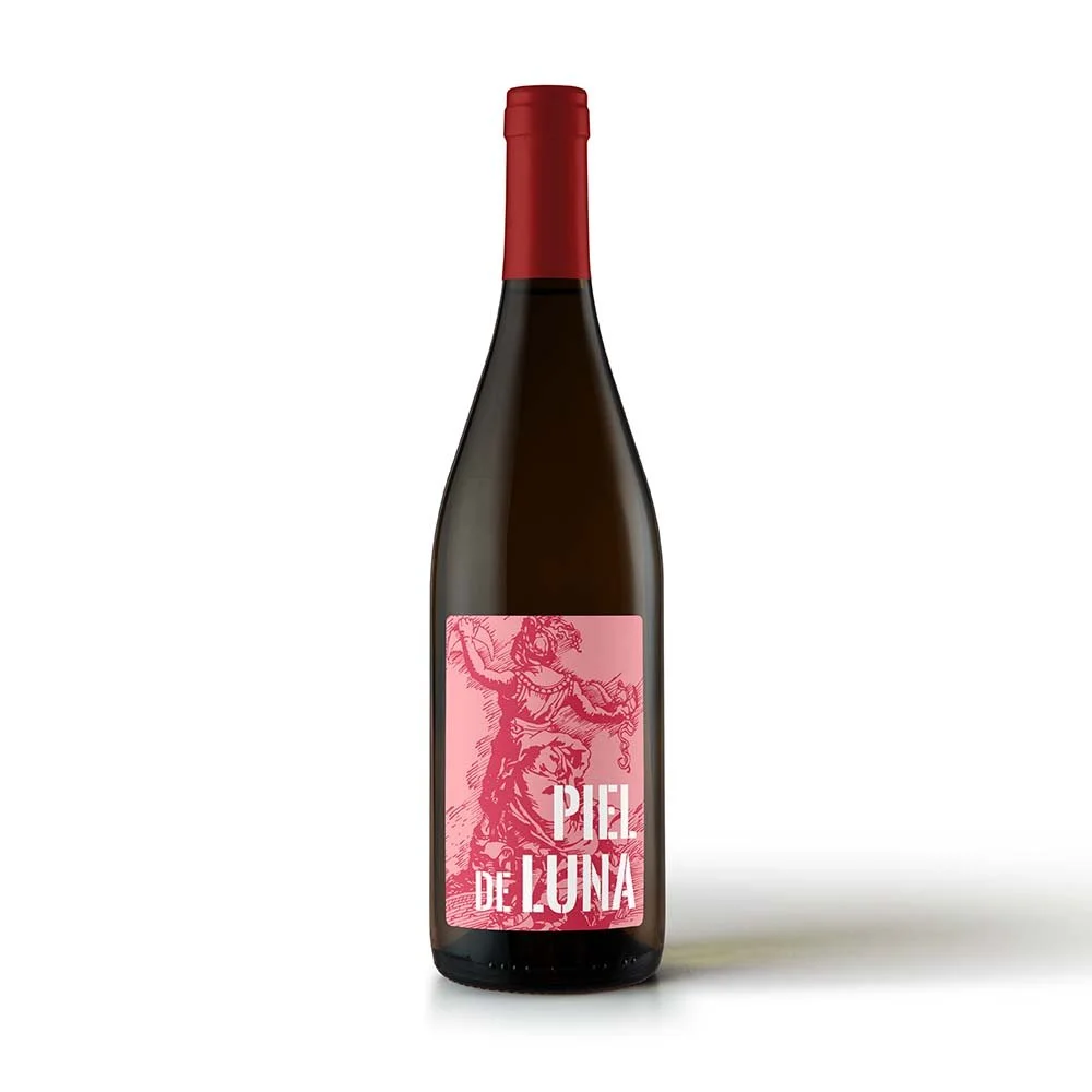 A dark glass wine bottle with a red foil capsule, featuring a pink label with an illustration of a goat and the text 'Piel de Luna'.