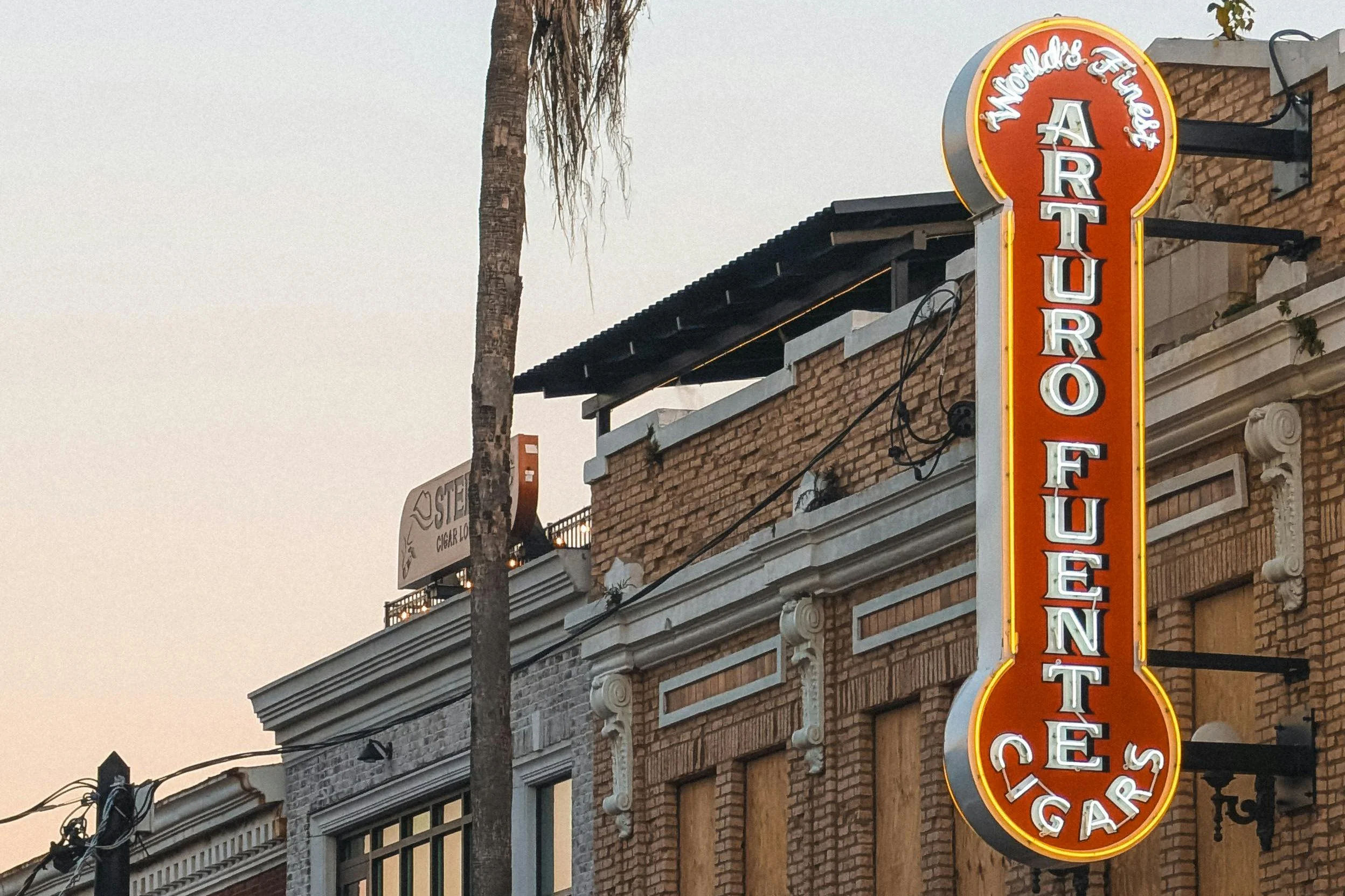 A red neon sign for Arturo Fuente World's Finest Cigars. Drives & Detours Ybor City history