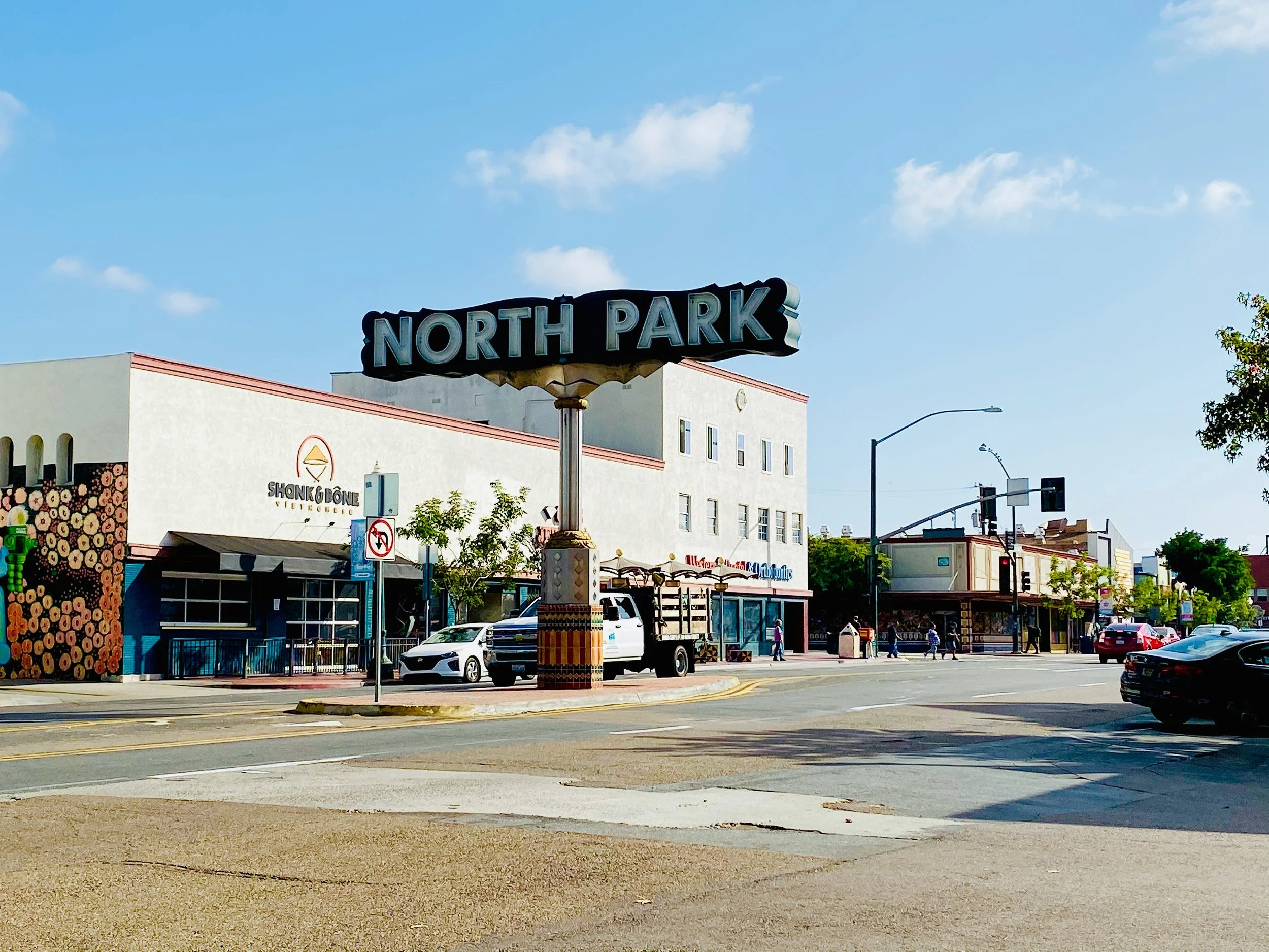 The San Diego North Park sign in front of a building with graffiti of flowers