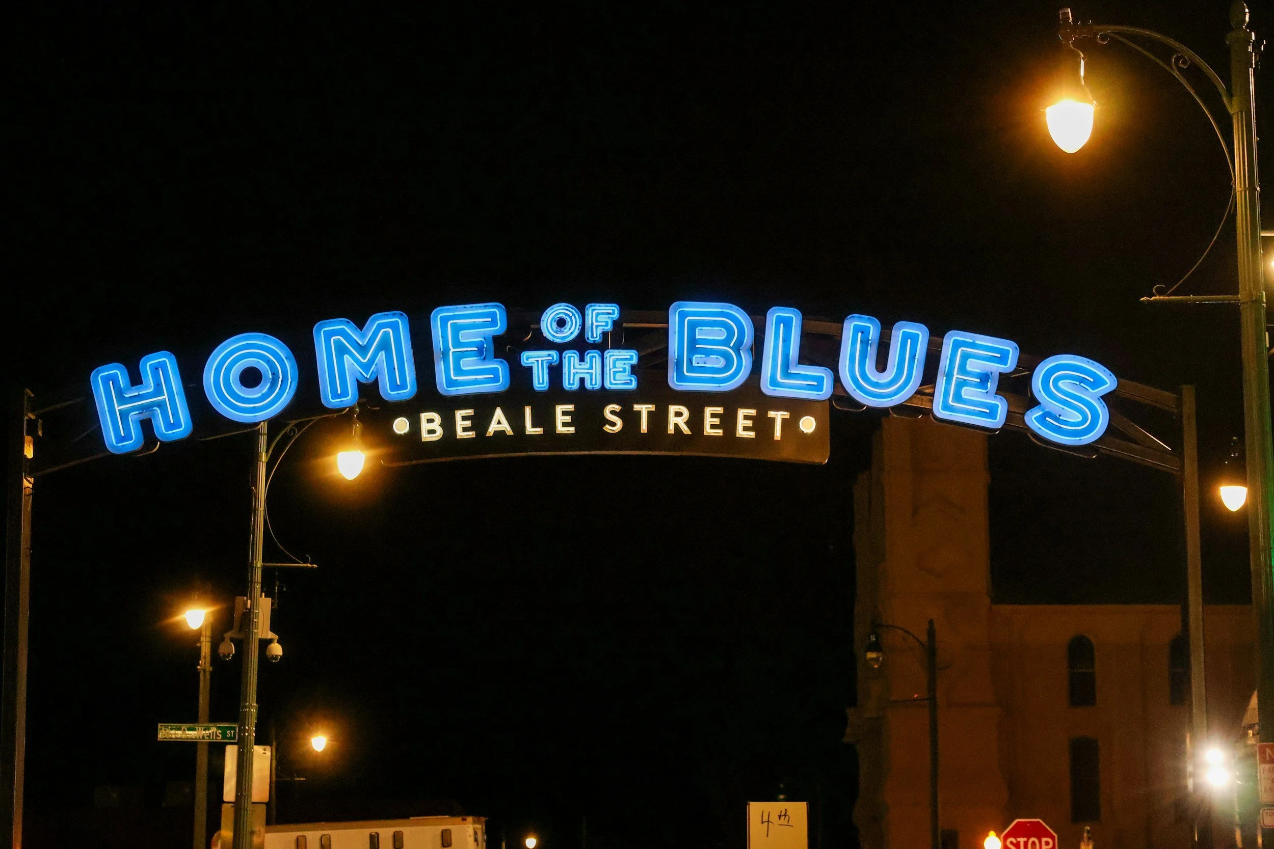 Home of the Blues: Beale Street, is written in large blue letters on a sign at night