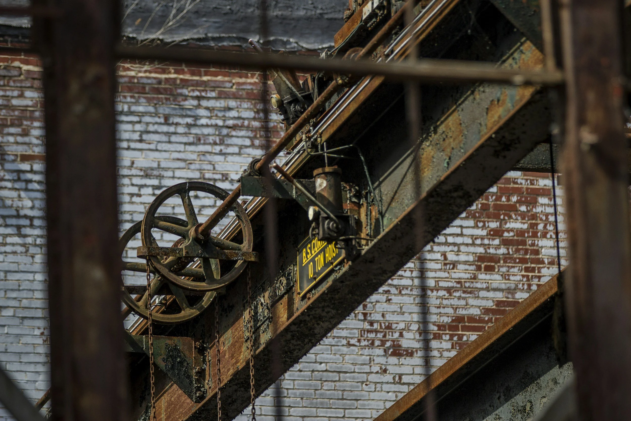 Pulleys and other heavy tools hang from steel rafters in the SteelStacks. Drives & Detours Bethlehem walking tour