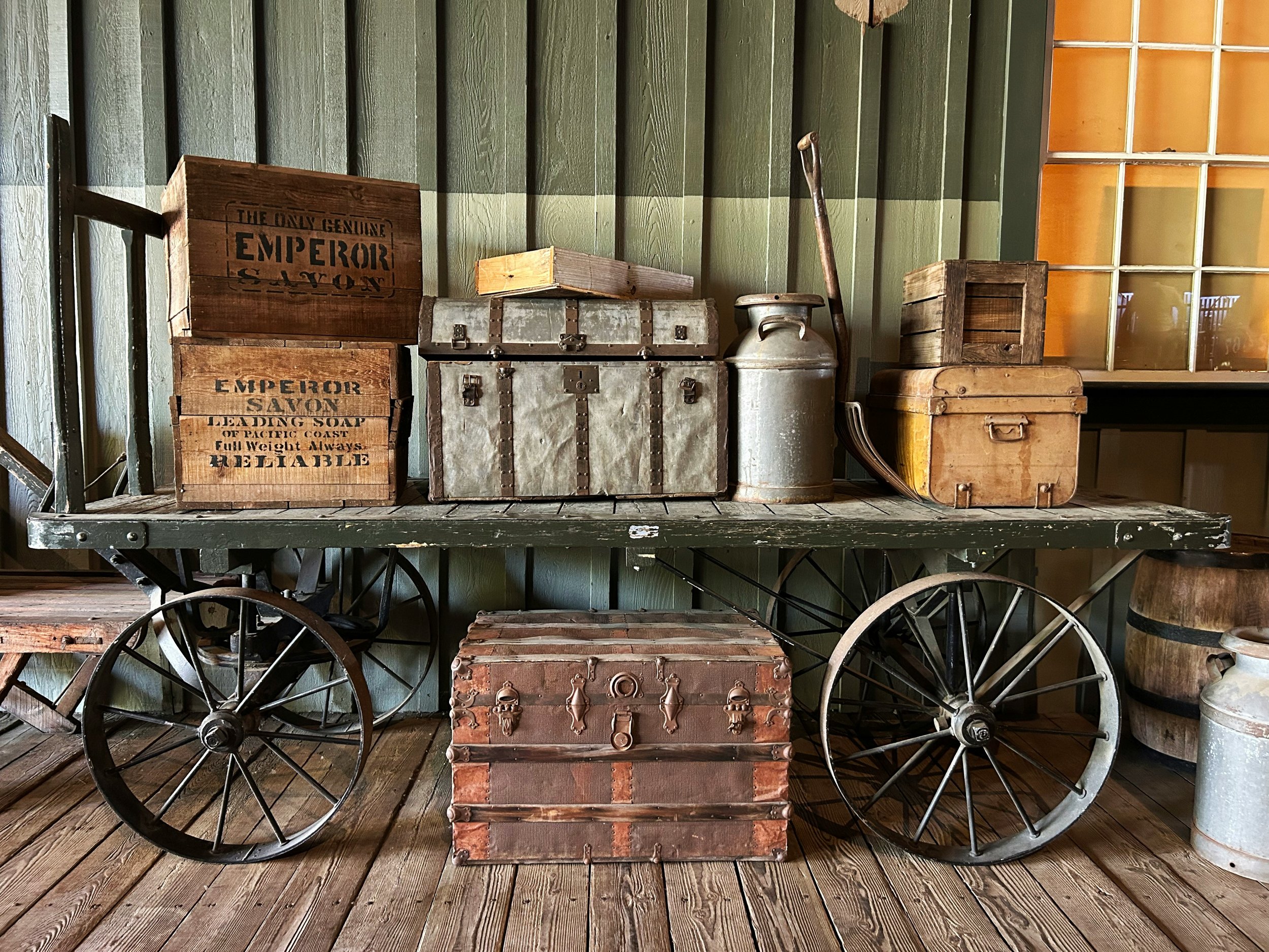 A wagon carrying boxes, milk urns, and luggage in Old Sacramento
