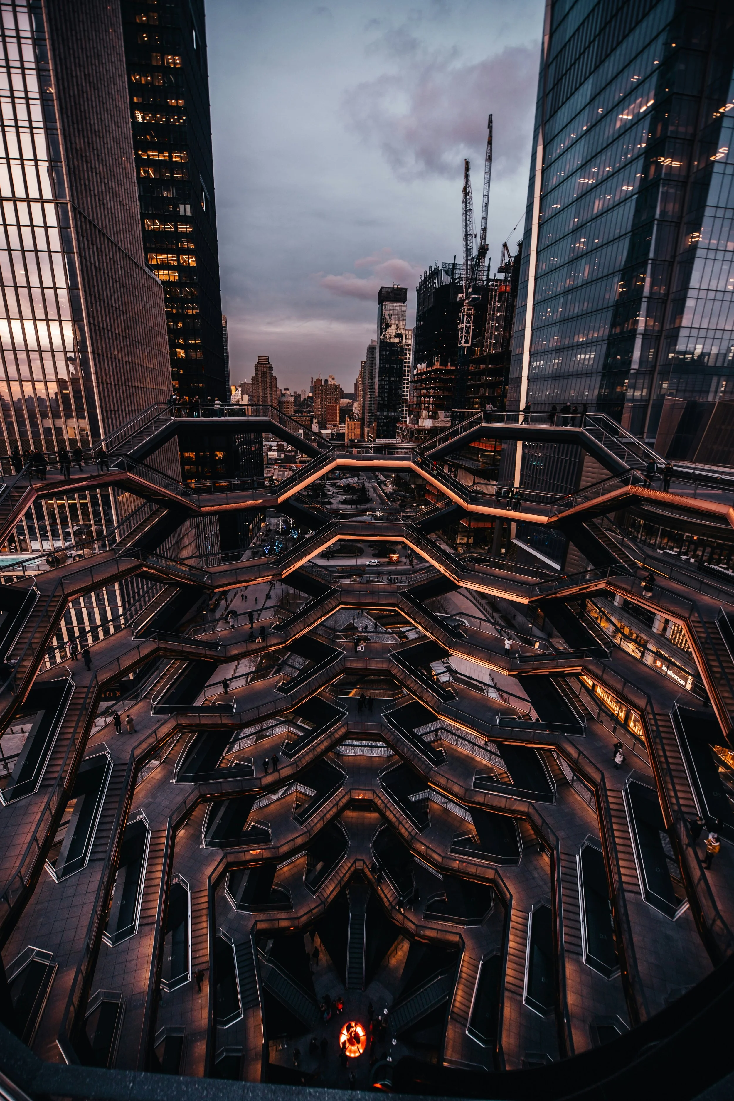 A view from the top of the Vessel in Hudson Yards. It is surrounded by skyscrapers which stretch into the distance. Drives & Detours New York High Line walking tour