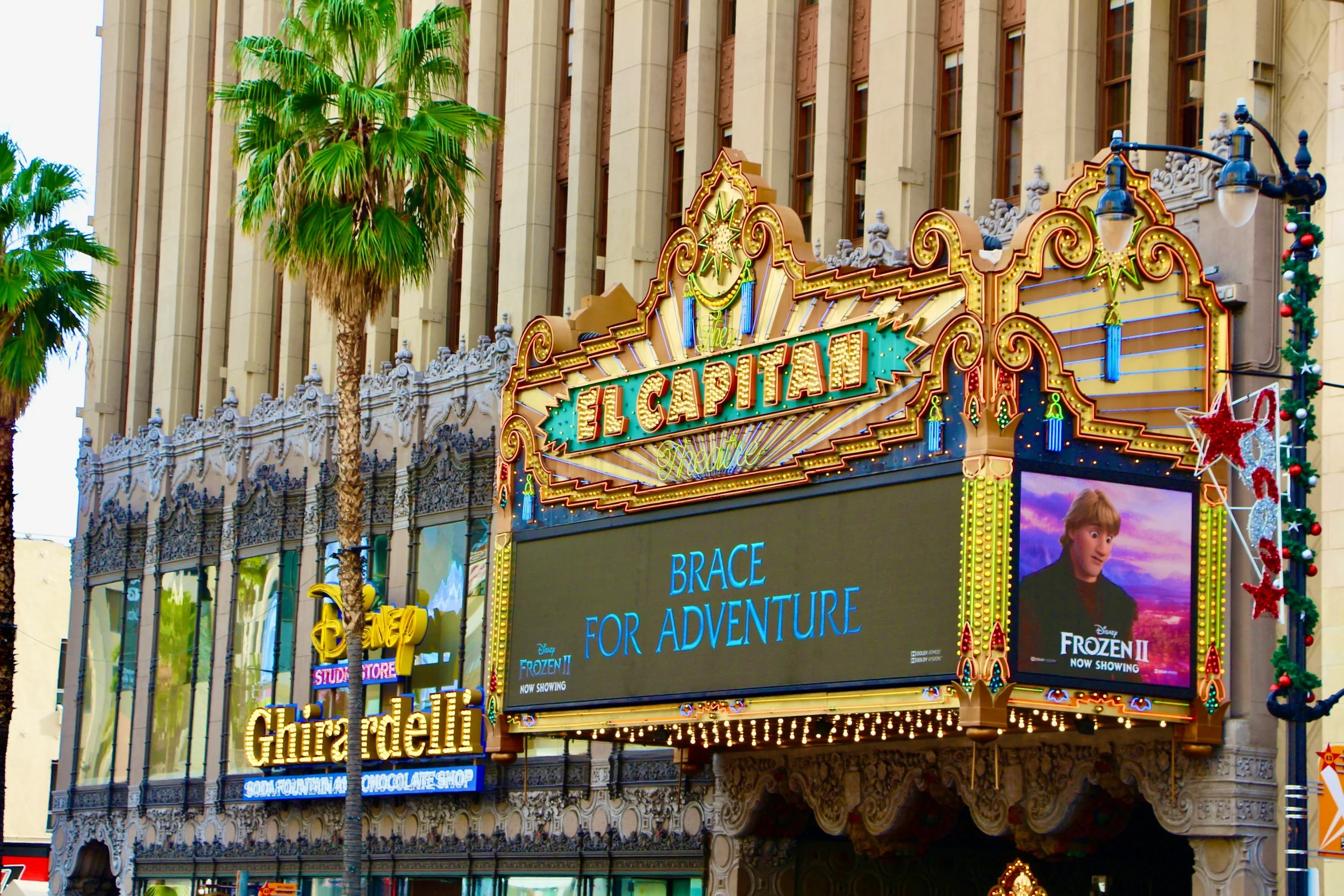 The El Capitan Theatre in Los Angeles, with its golden sign lit up in neon.