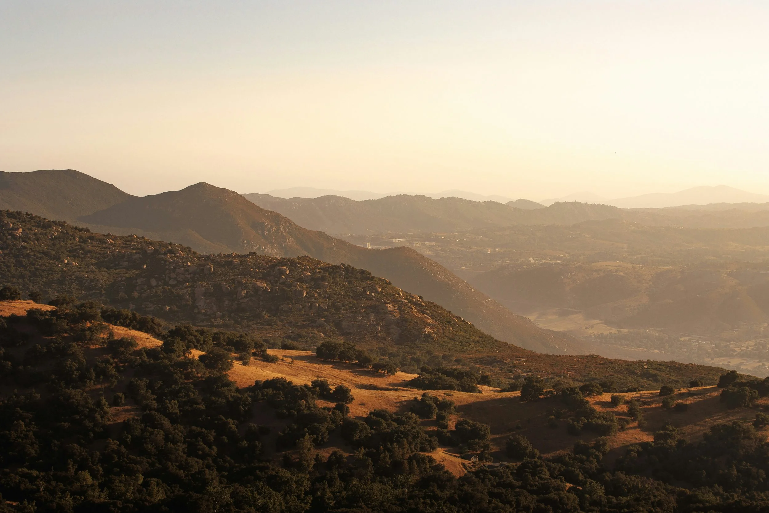 The sun sets over the Pauma Valley near san Diego. The ridges of different hills catch the light in different ways. Some are orange and some are almost pitch black