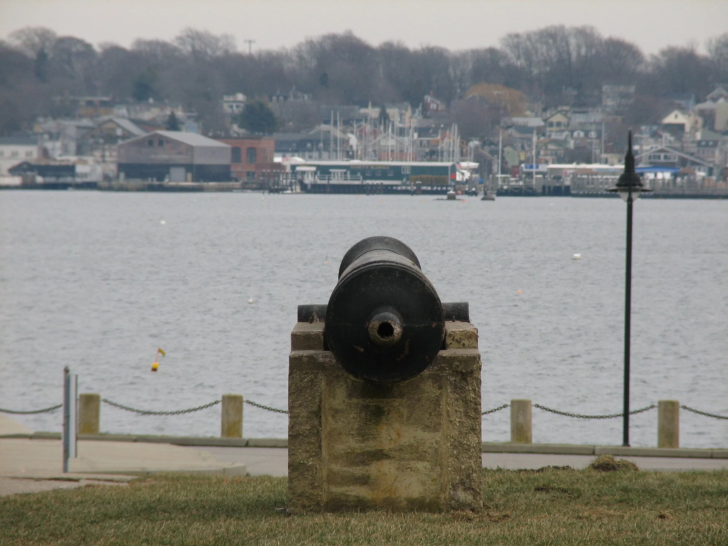 A cannon sits in the center of the picture, facing out towards sea