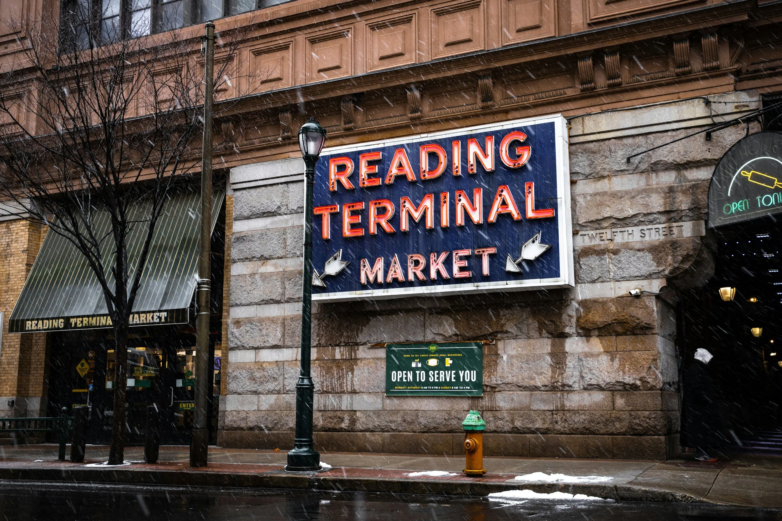 A large sign on the side of a building reads: Reading Terminal Market. Drives & Detours top attractions Philadelphia
