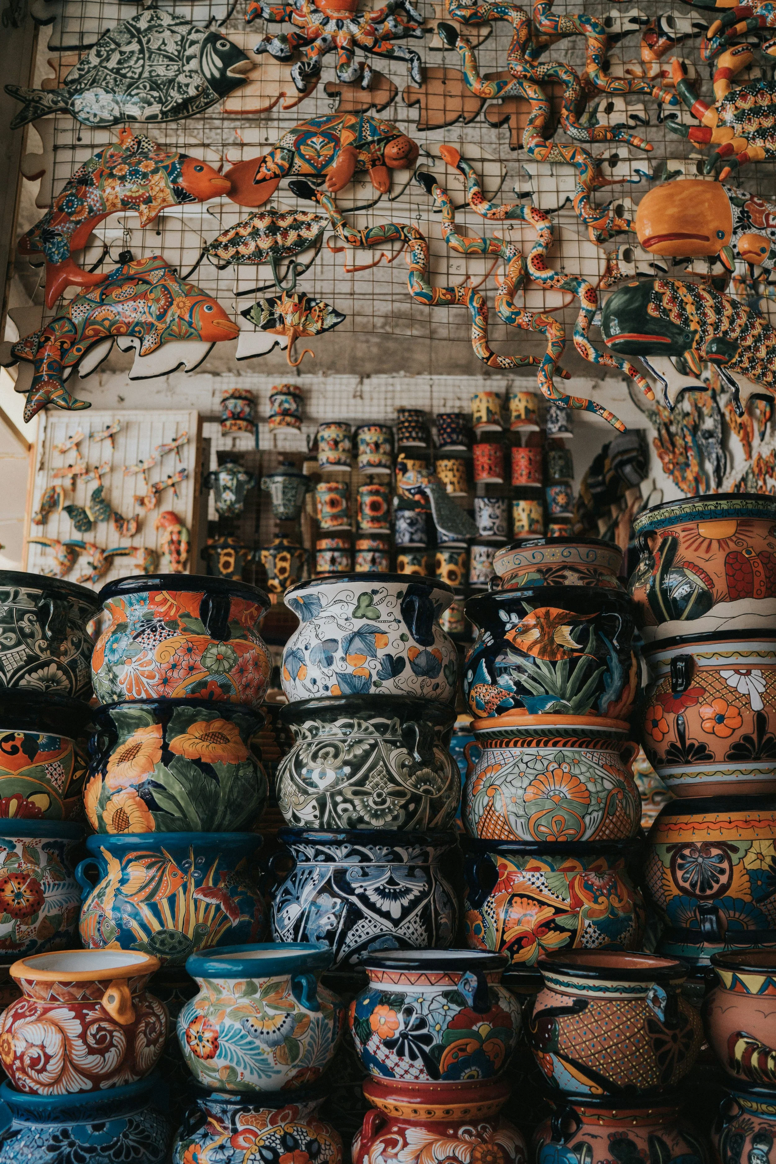 A pottery store in Santa Fe is full of pots, mugs and fish covered in detailed, patterned, multi-colored designs
