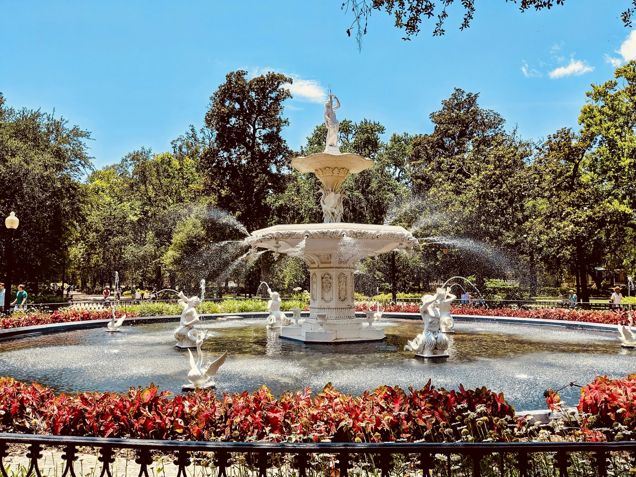 A huge white fountain surrounded by flowers in one of the parks of Savannah, Georgia. Drives & Detours Savannah self-guided tour