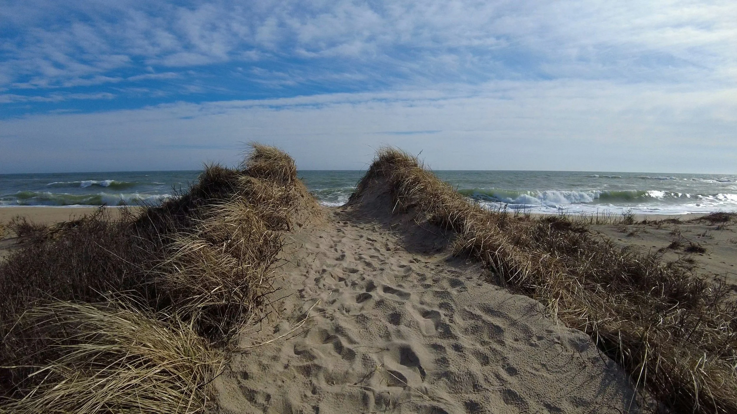 Waves crash beside a sand dune on South Beach, also known as Katama Beach. Drives & Detours things to do in Martha's Vineyard