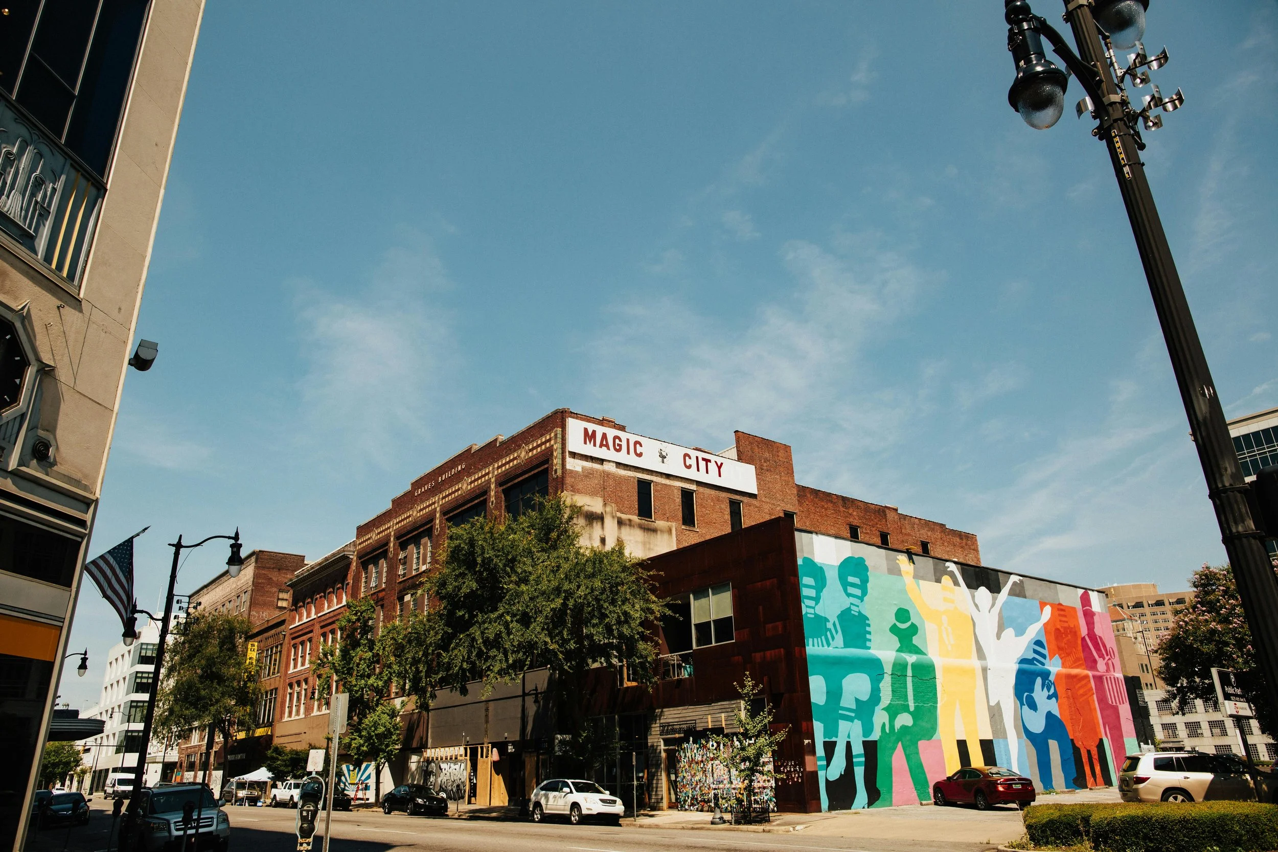 A huge multicolored mural shows people dancing and palying instruments under a sign that reads: Magic City. Drives & Detours First-time visitor guide Birmingham