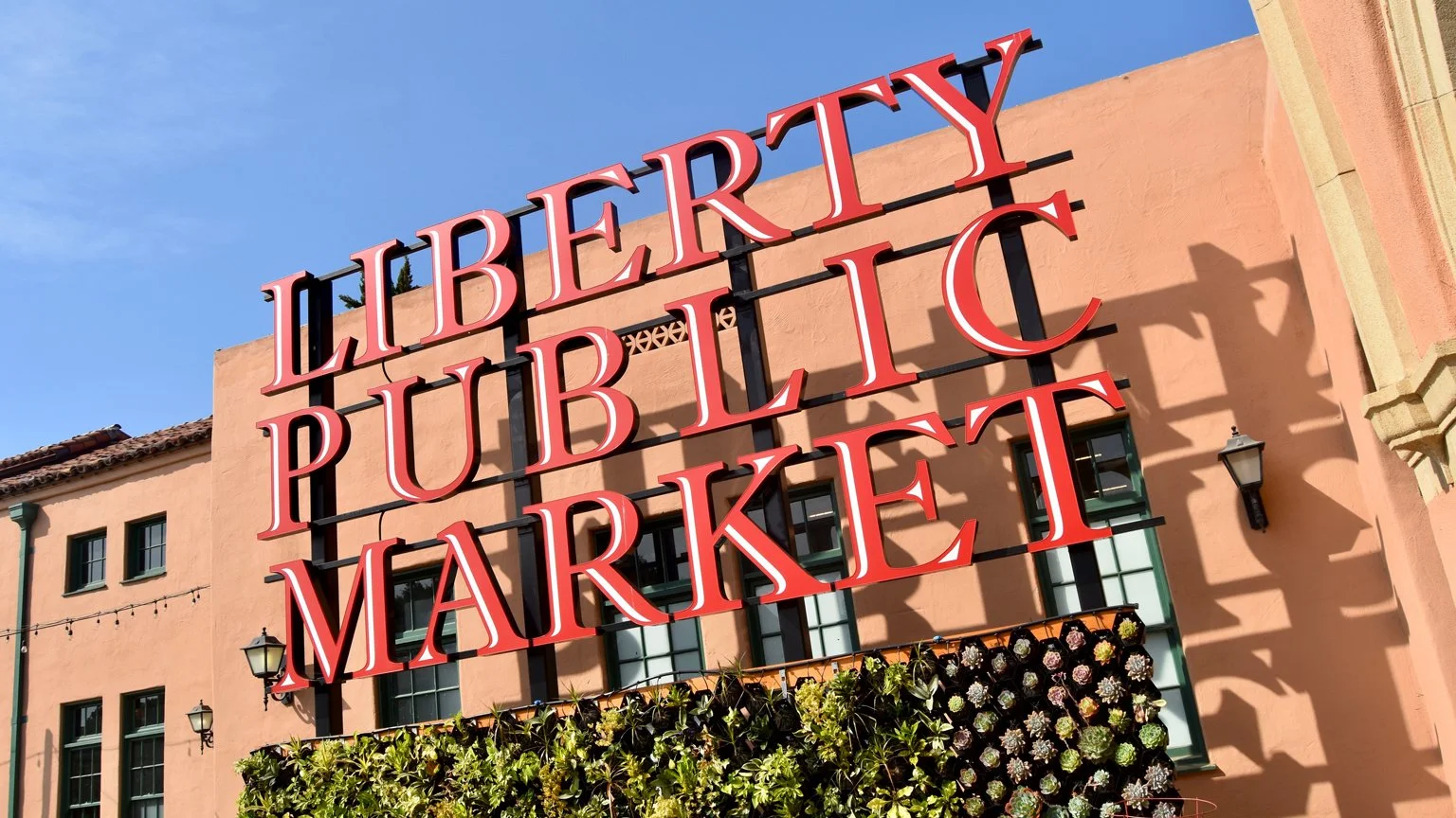 The sign at the entrance to Liberty Station Public Market. It is in large red lettering on the side of a building