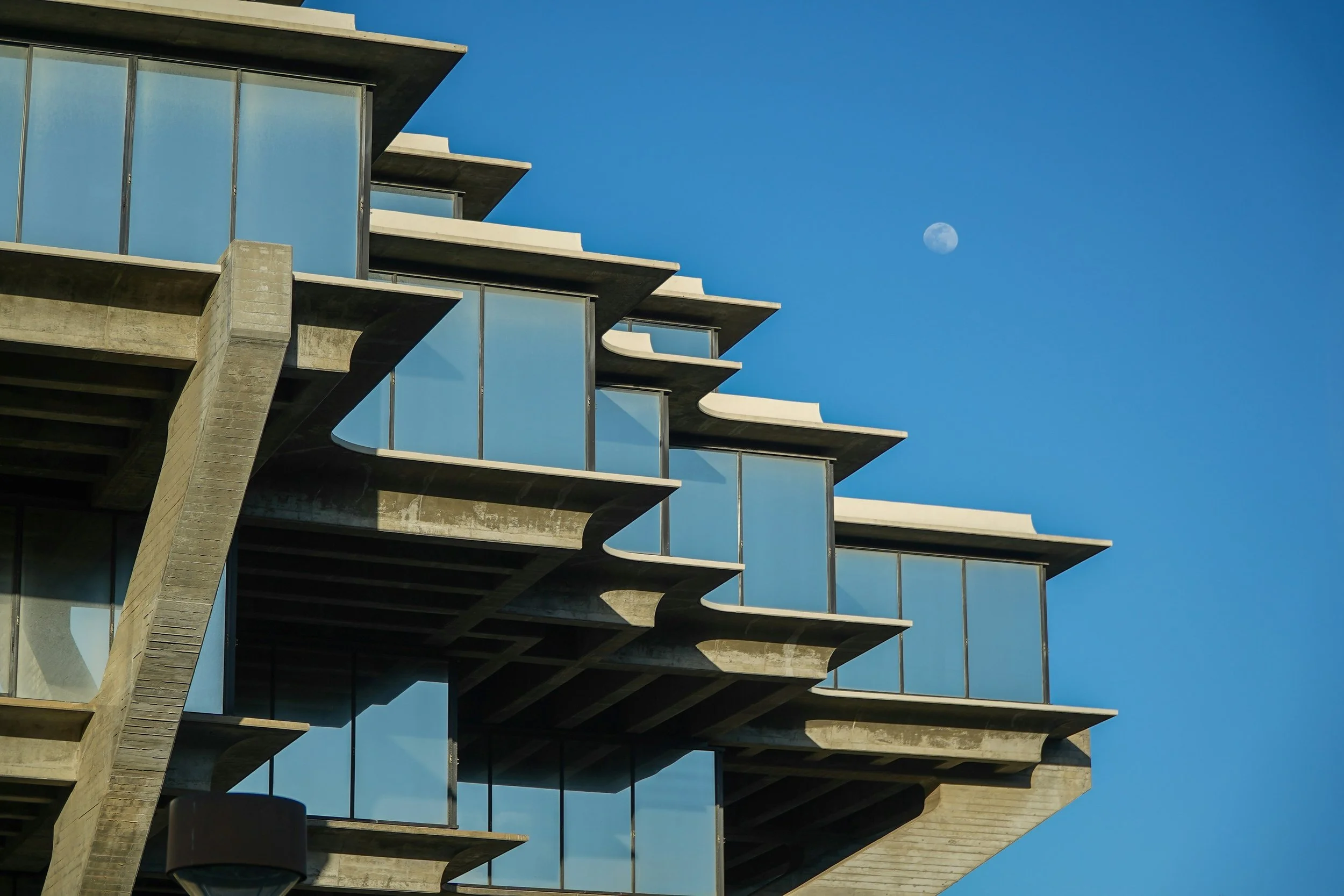 The moon is up during the day over the library at UCSD in La Jolla. Drives & Detours San Diego Driving Tour