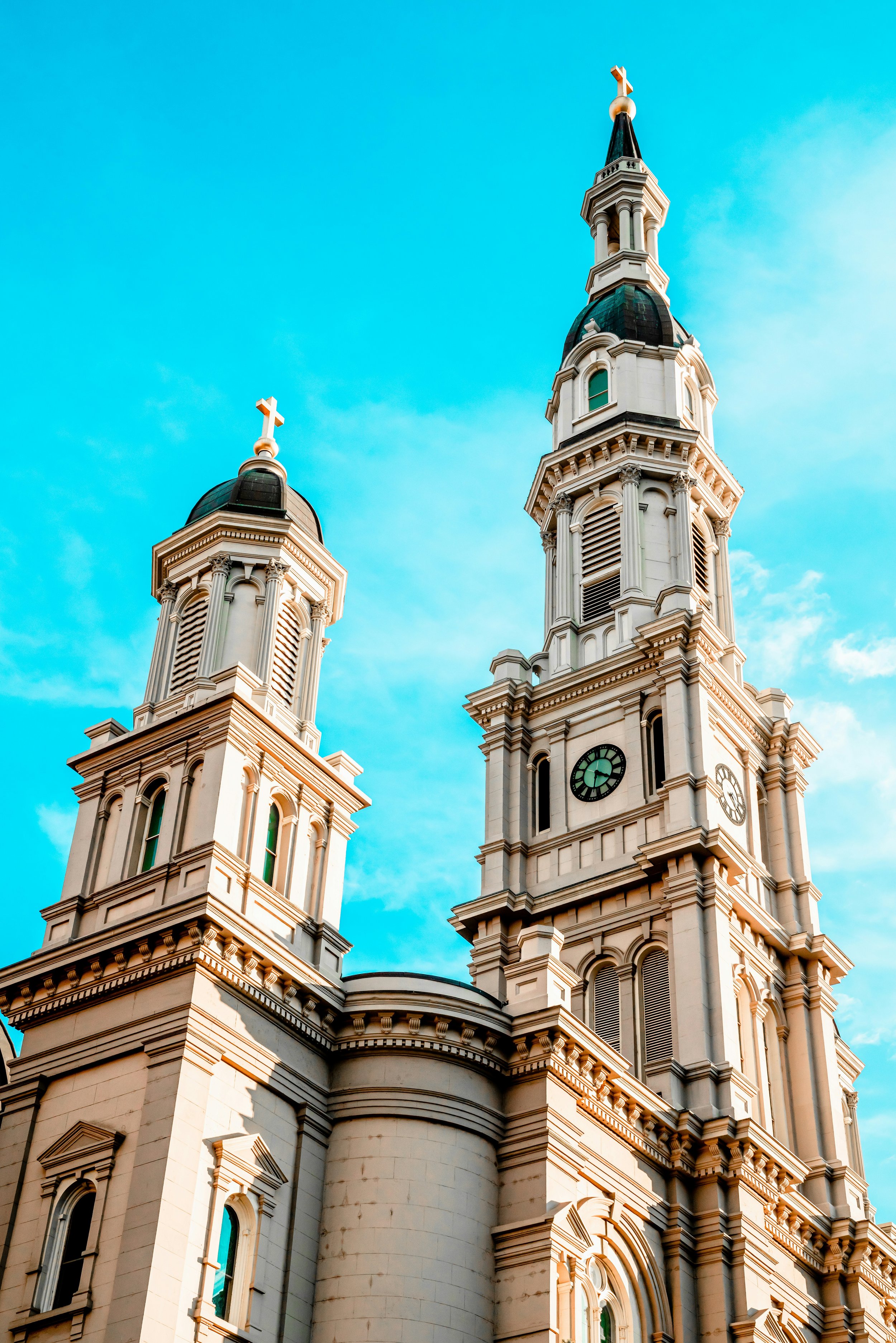 The two steeples of a church in Old Sacramento. The sky behind them is a bright blue