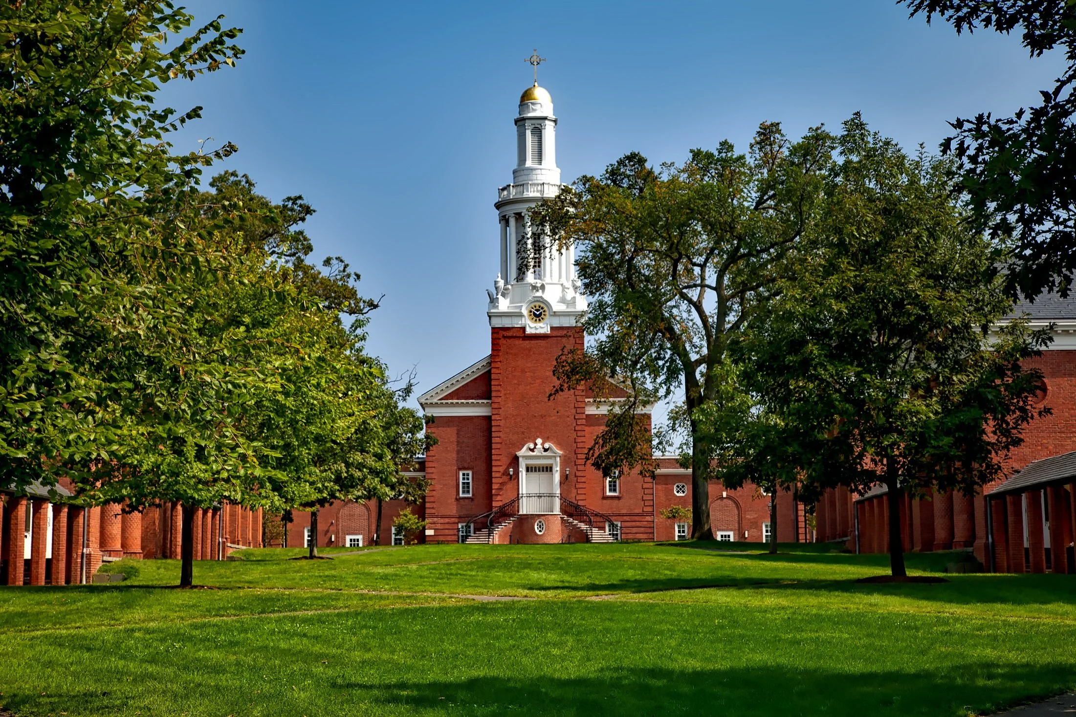 A large red brick building with a white tower sits at the end of a college green. Drives & Detours Top sights at Yale