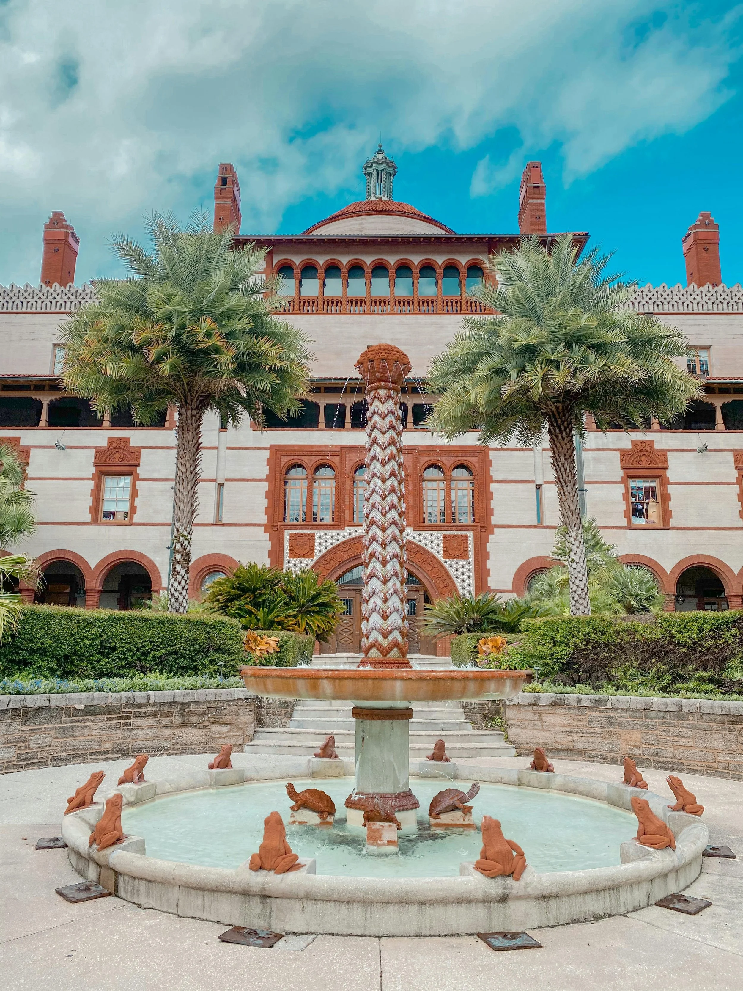 Water flows from a fountain in front of the Flagler College in St. Augustine. This used to be the Ponce de Leon Hotel. The fountain is surrounded by clay frogs and turtles