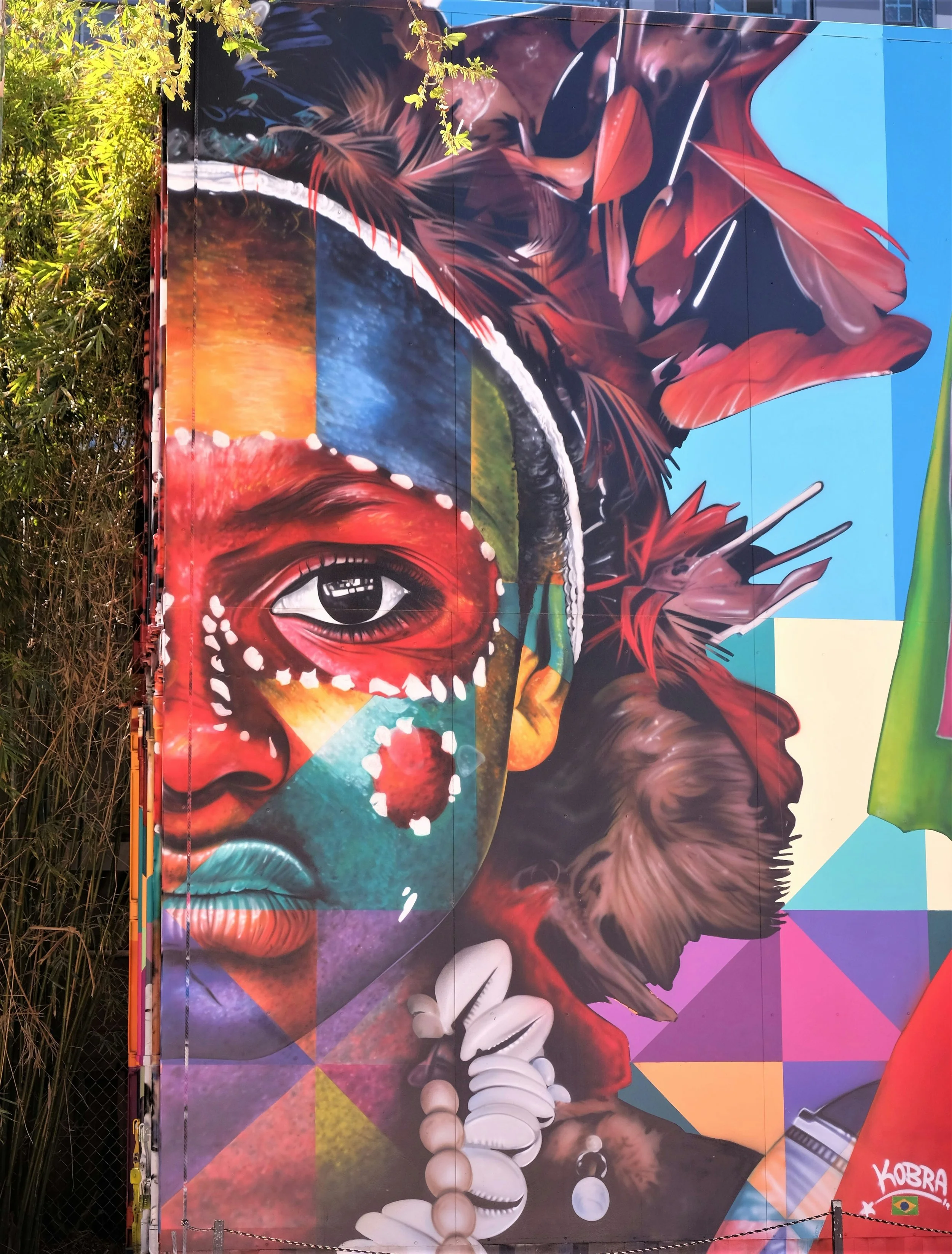 Street art in Wynwood, Miami. A woman's face is painted on a wall in multiple colors