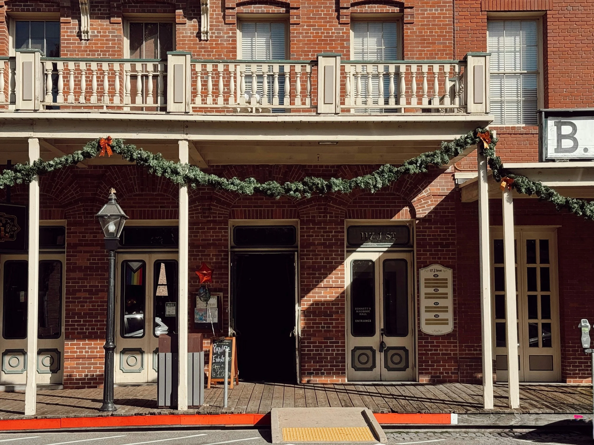 A red brick shop with a wooden balcony in Old Sacramento, California