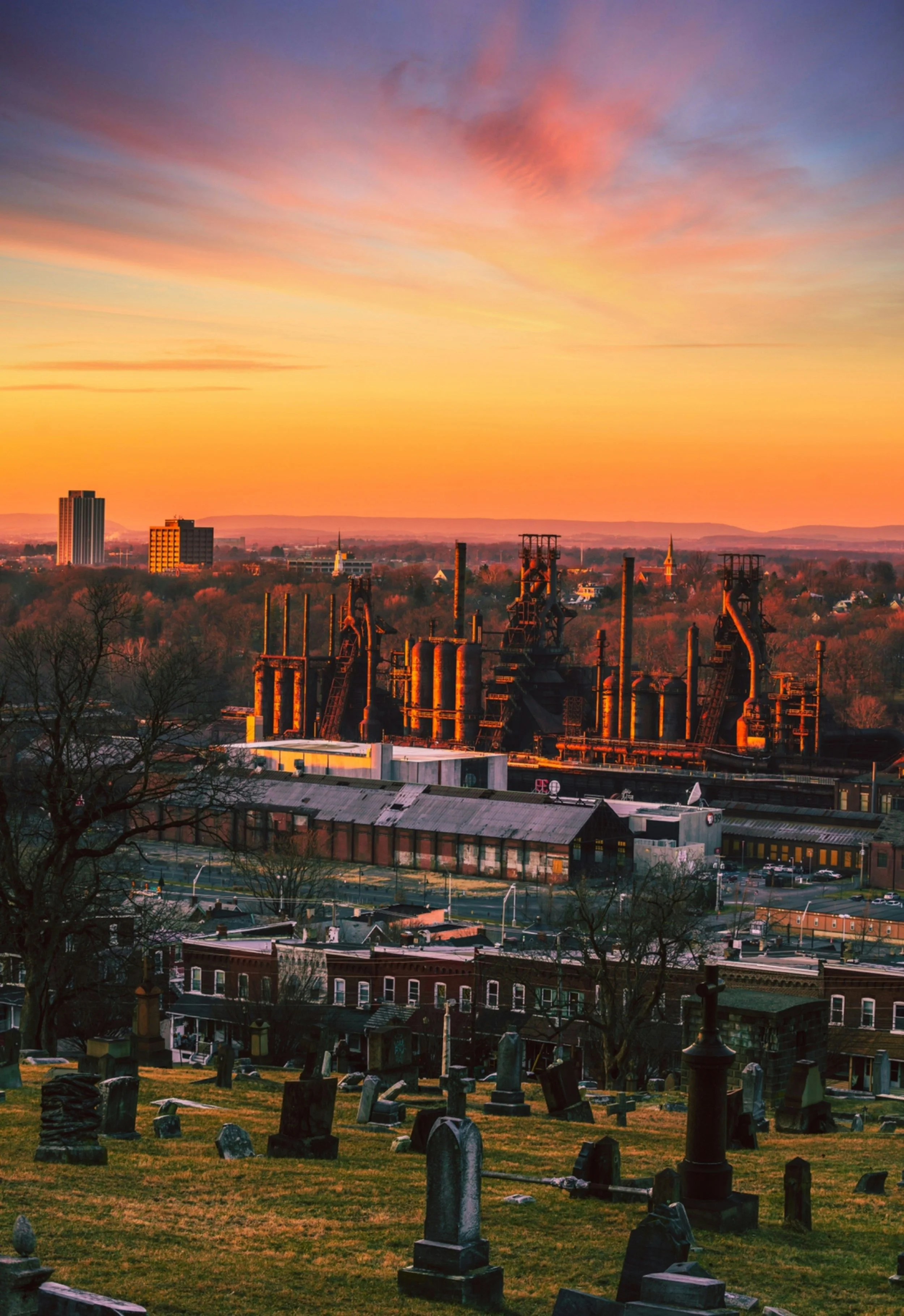 The SteelStacks can be seen over rows of red brick houses at sunset. Drives & Detours Bethlehem walking tour