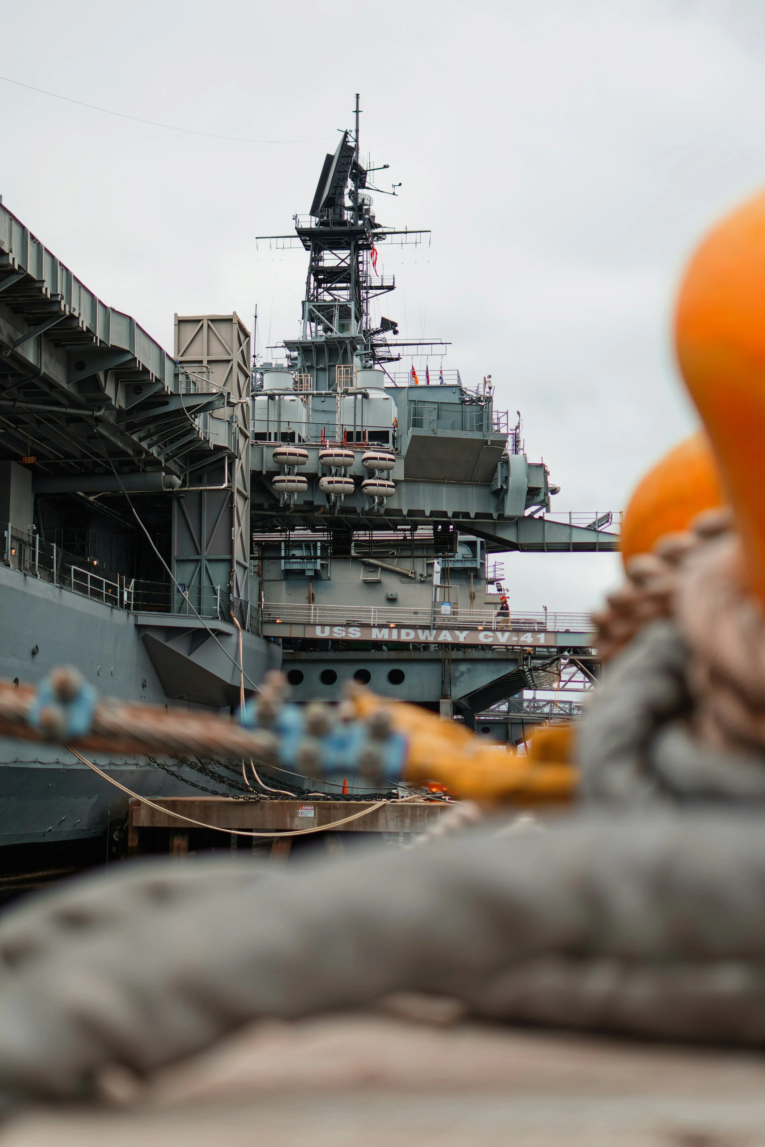 The bridge of the USS Midway can be seen towering over the dock. Drives & Detours USS Midway Museum and Embarcadero Self-Guided Tour