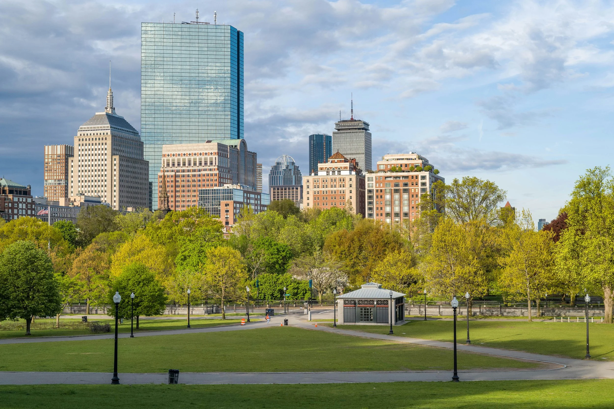 Skyscrapers tower over Boston Common, which is full of trees and green space