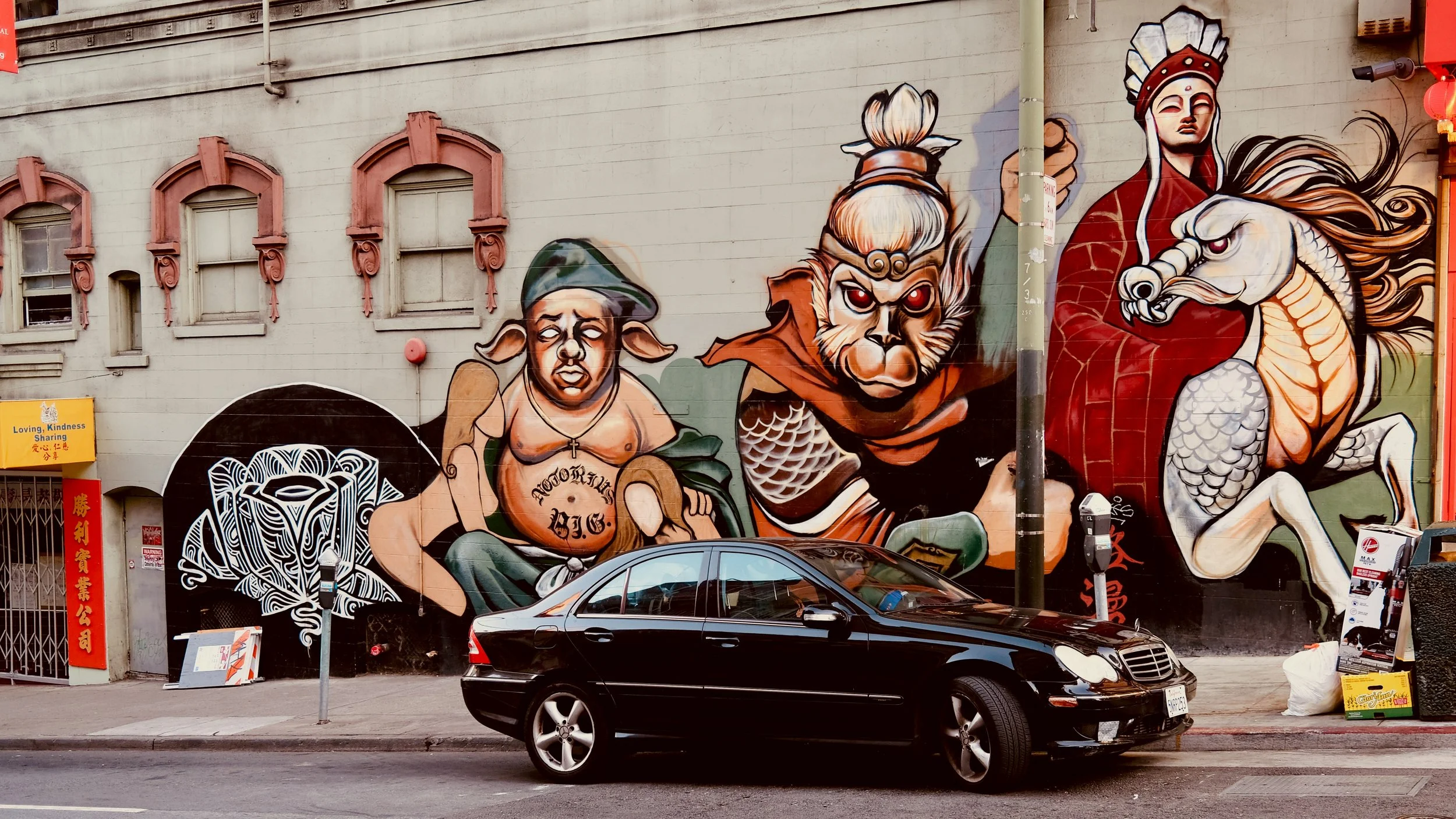 A mural in San Francisco Chinatown shows various characters in different poses