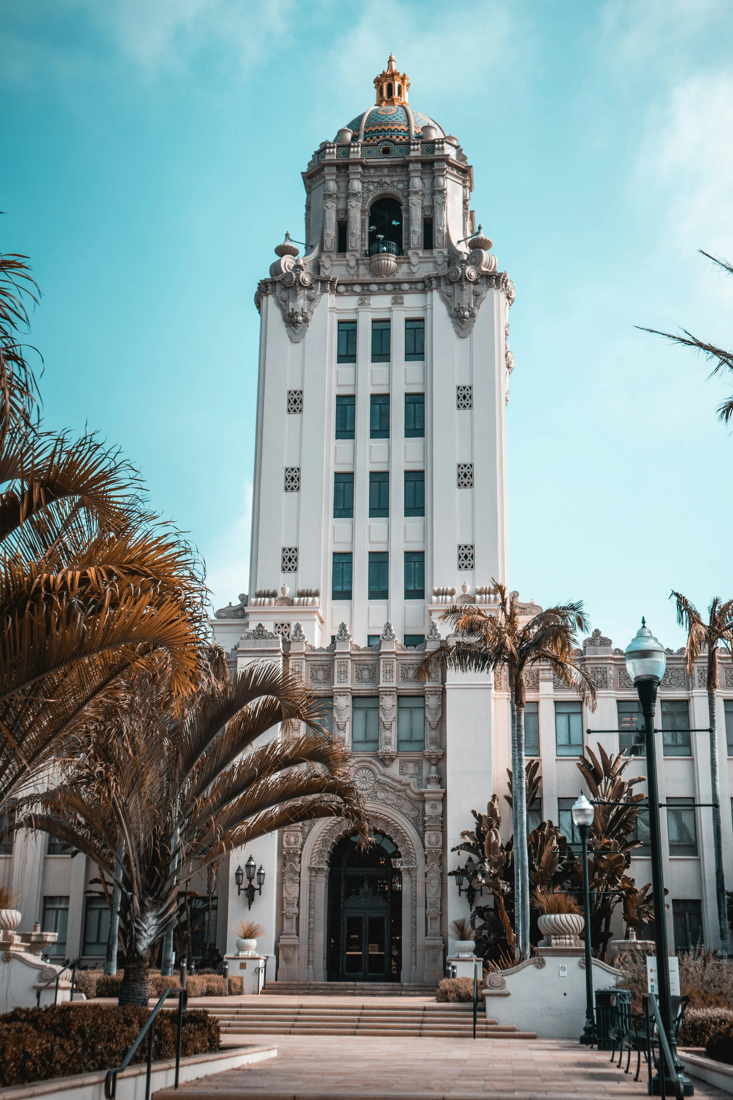 The Spanish Colonial Revival Beverly Hills City Hall towers over palm trees in Los Angeles