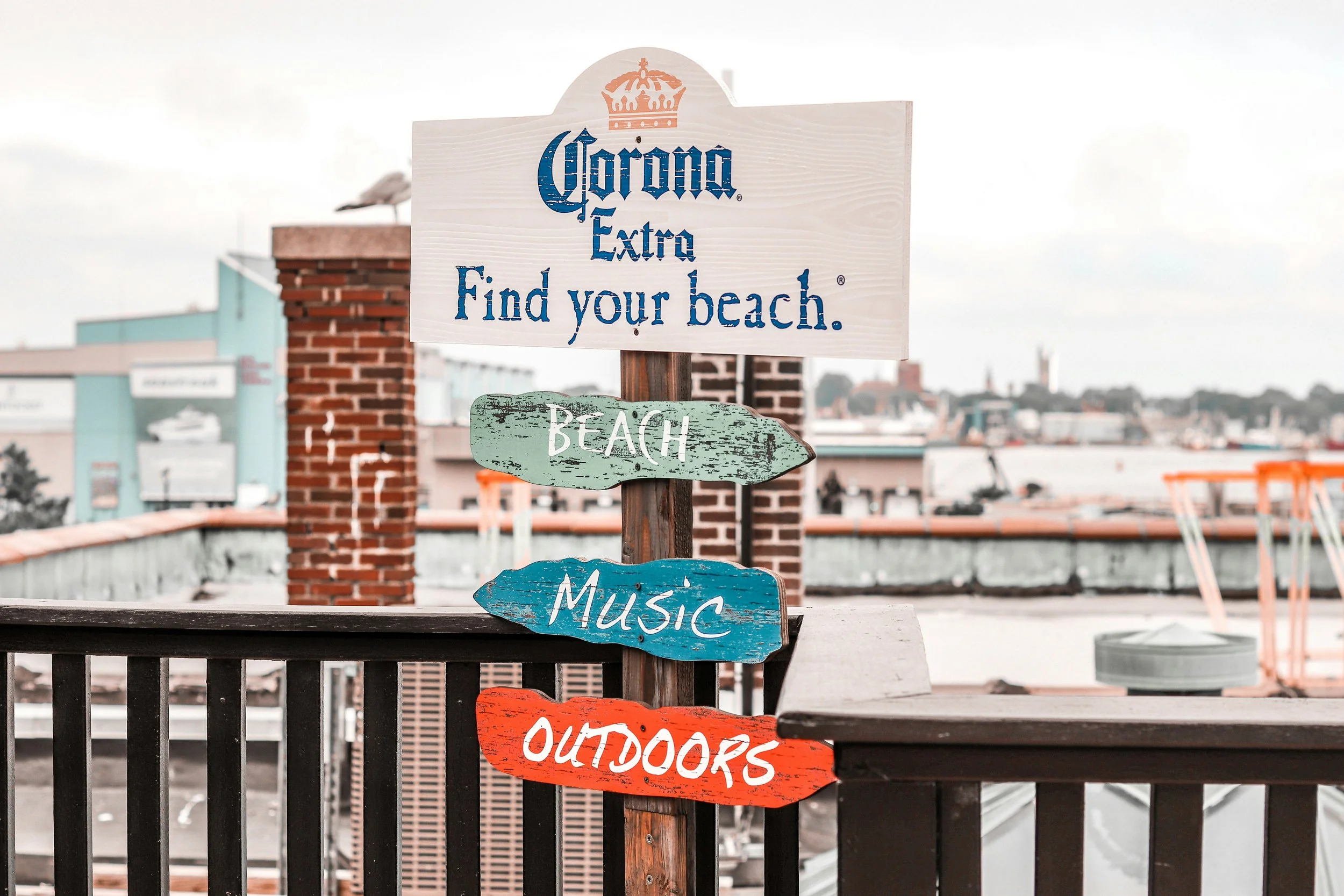 Wooden signs in New Bedford, MA, point to the Beach, Music and Outdoors
