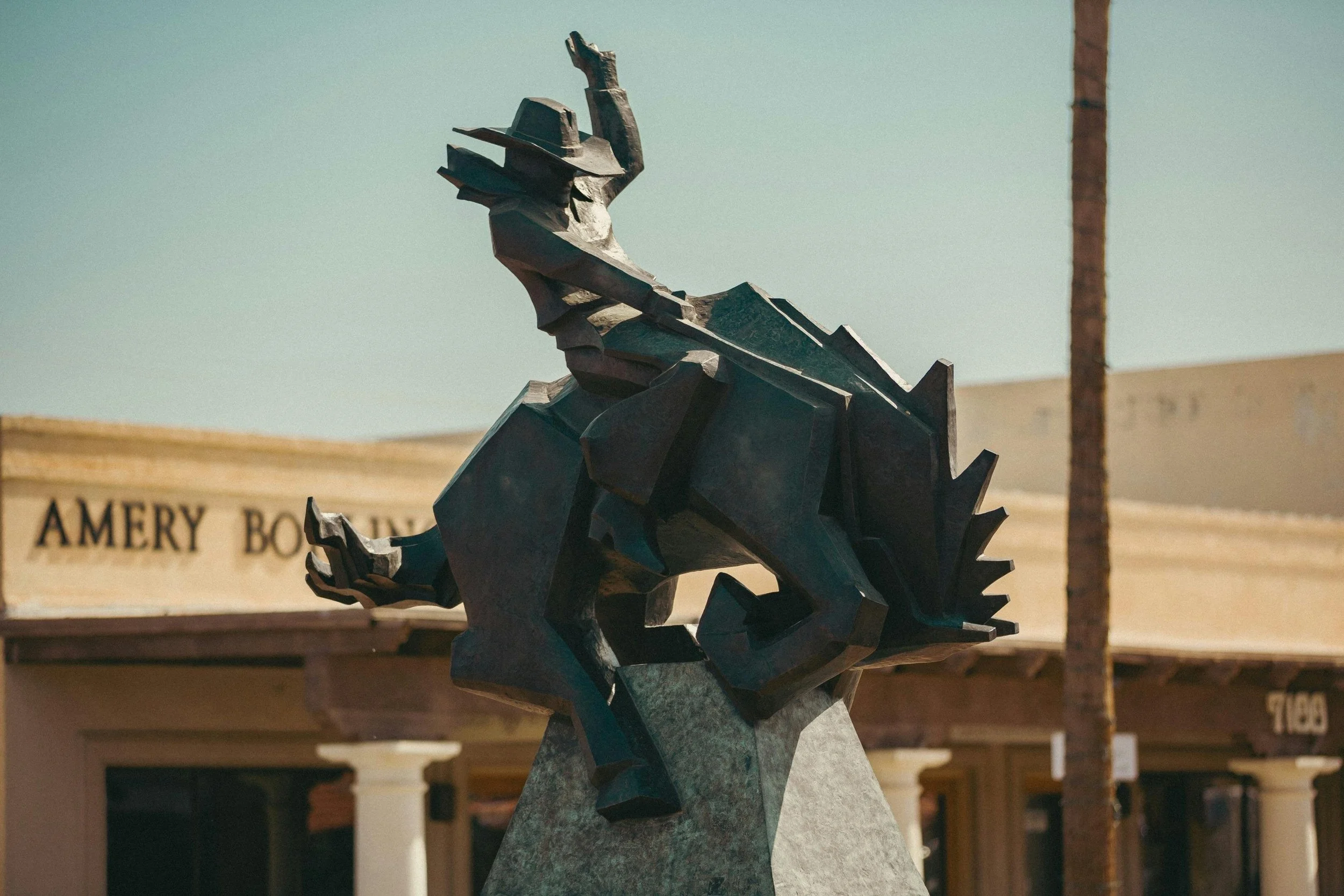 A statue of a cowboy riding a bucking horse in Scottsdale, Arizona. It's a modern statue, full of action and movement. Drives & Detours Scottsdale self-guided tour