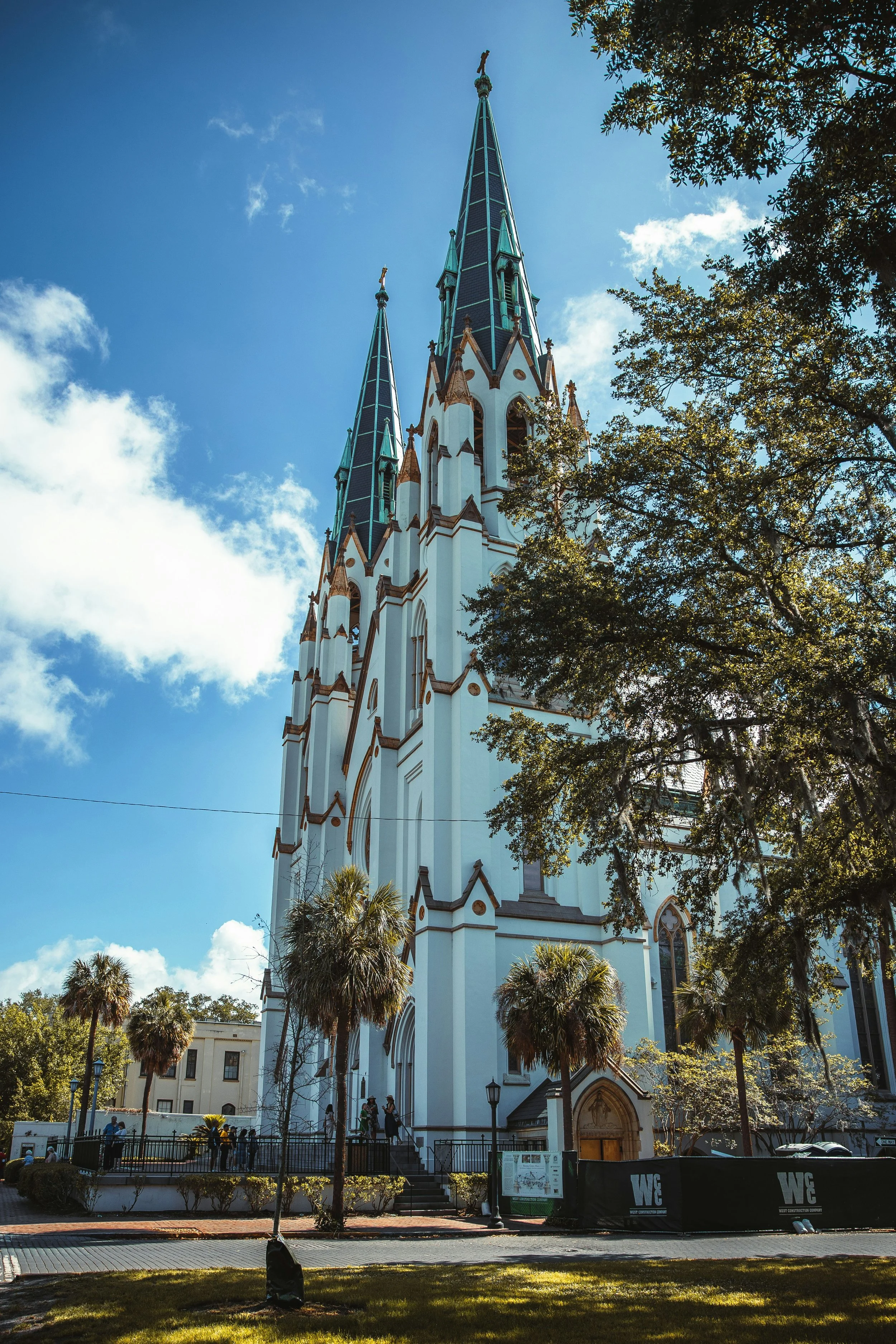 The huge white Cathedral Basilica of St. John the Baptist in Savannah, Georgia. It hase blue spires. Drives & Detours Savannah self-guided tour