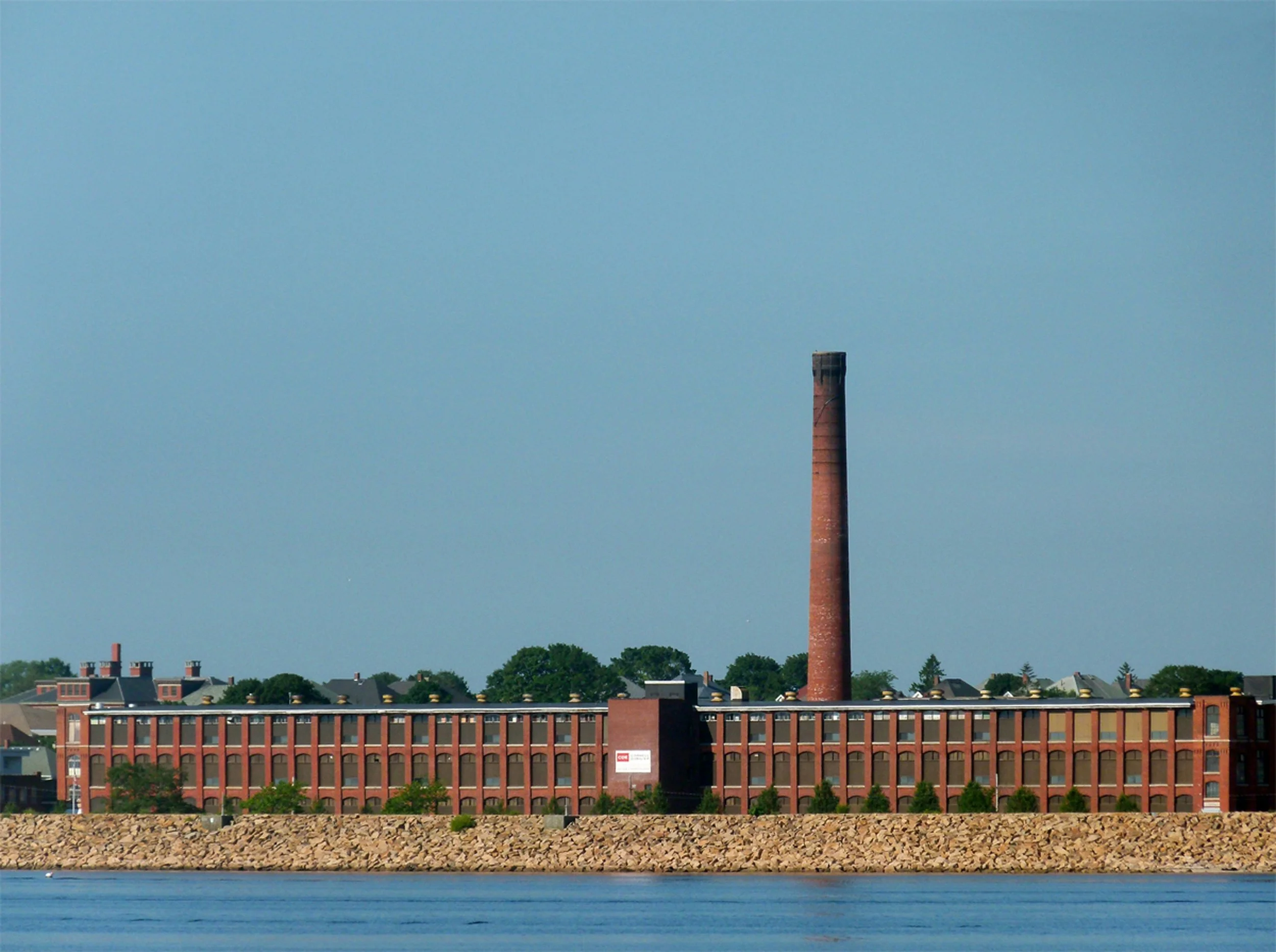 A Victorian brick factory stretches along a New England shoreline. Drives & Detours New Bedford walking tour