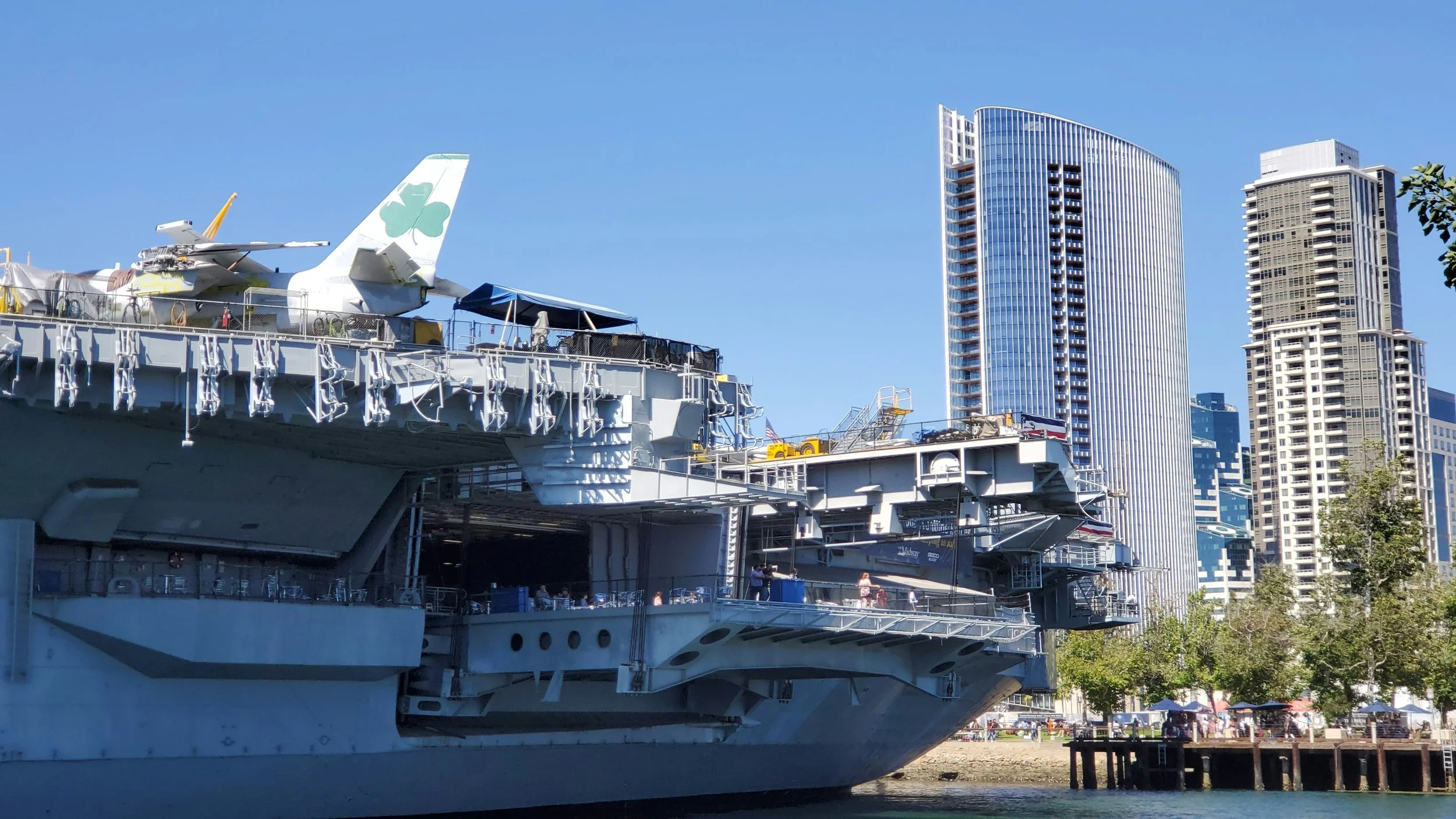 Skyscrapers rise from Tuna Harbor, San Diego, with the USS Midway in the foreground. Drives & detours USS Midway history