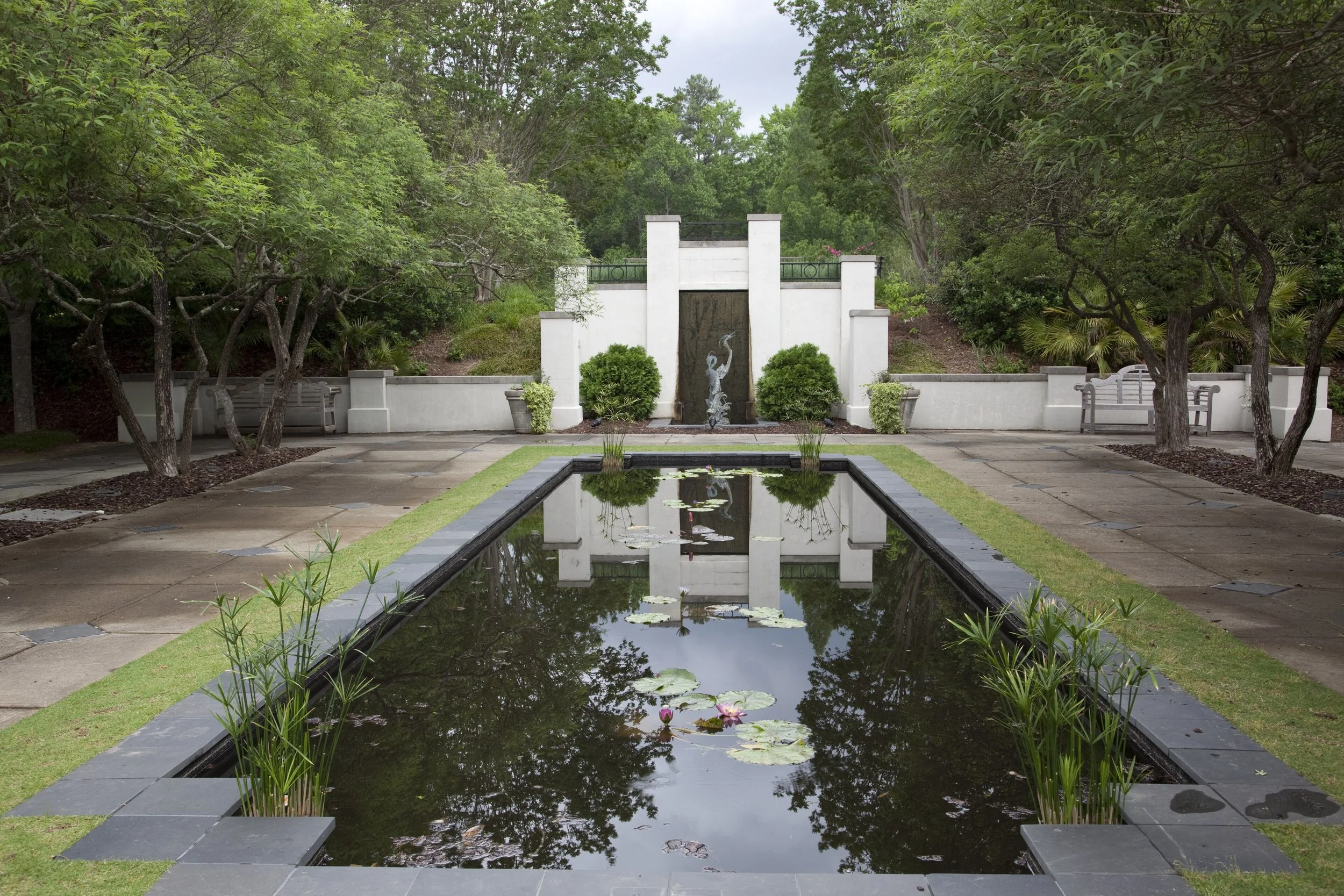 A statue is reflected in a mirror pond in Birmingham Botanical Gardens, Alabama.