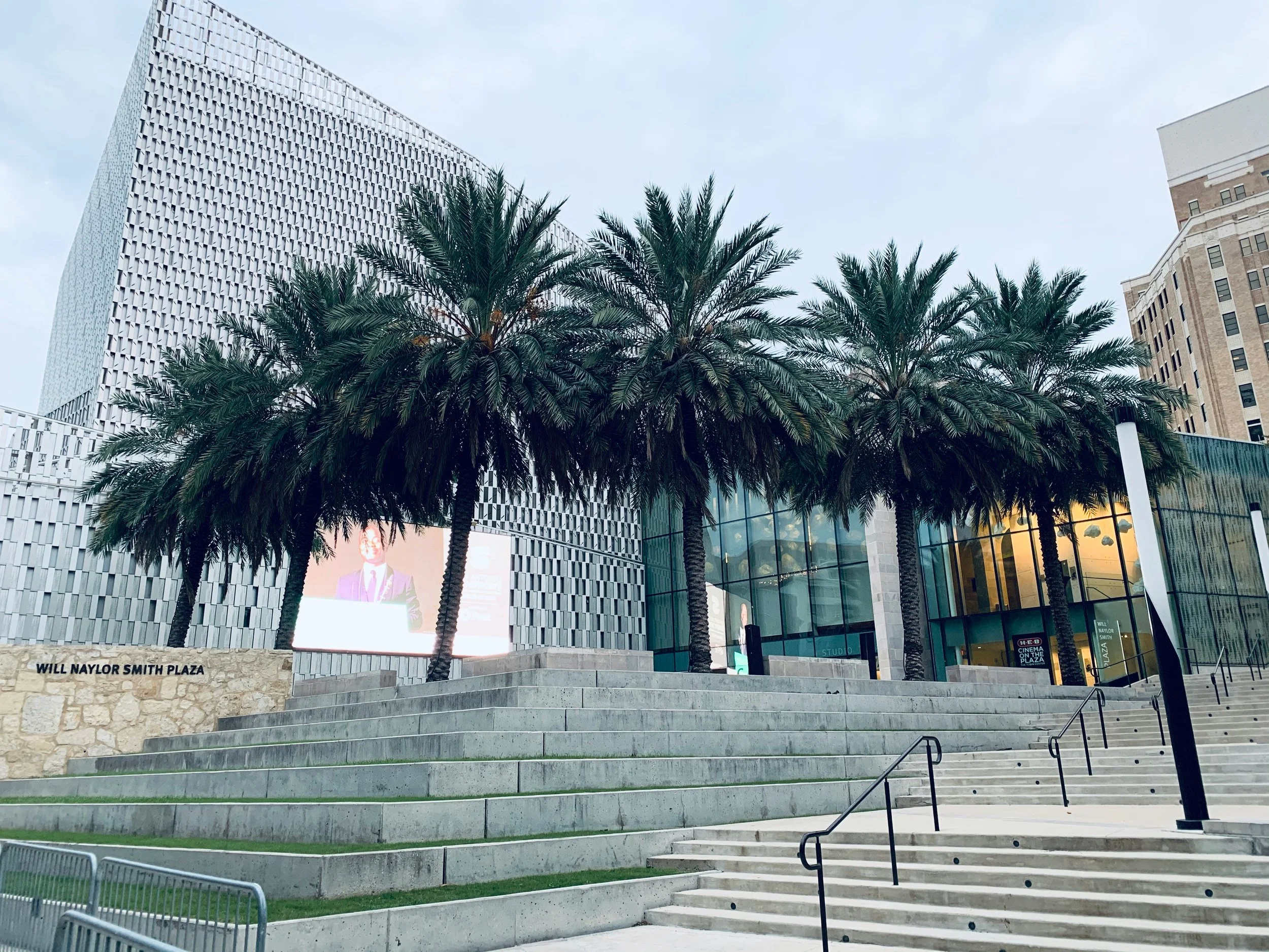 Will Naylor Smith Plaza in the Museum Reach is full of palm trees and surrounded by modern glass buildings. Drives & Detours San Antonio self-guided tour